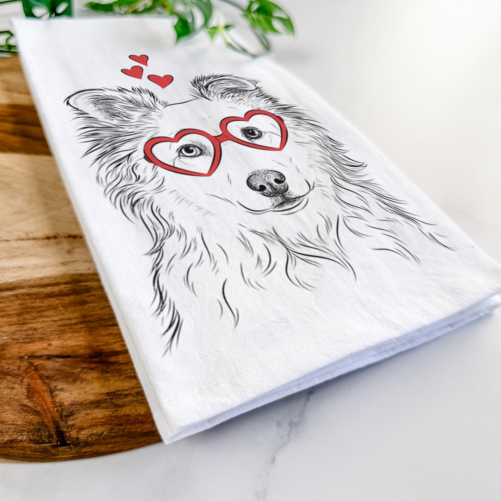 Hand-drawn sketch of Bonsai the Mixed Breed wearing heart-shaped glasses on a tea towel