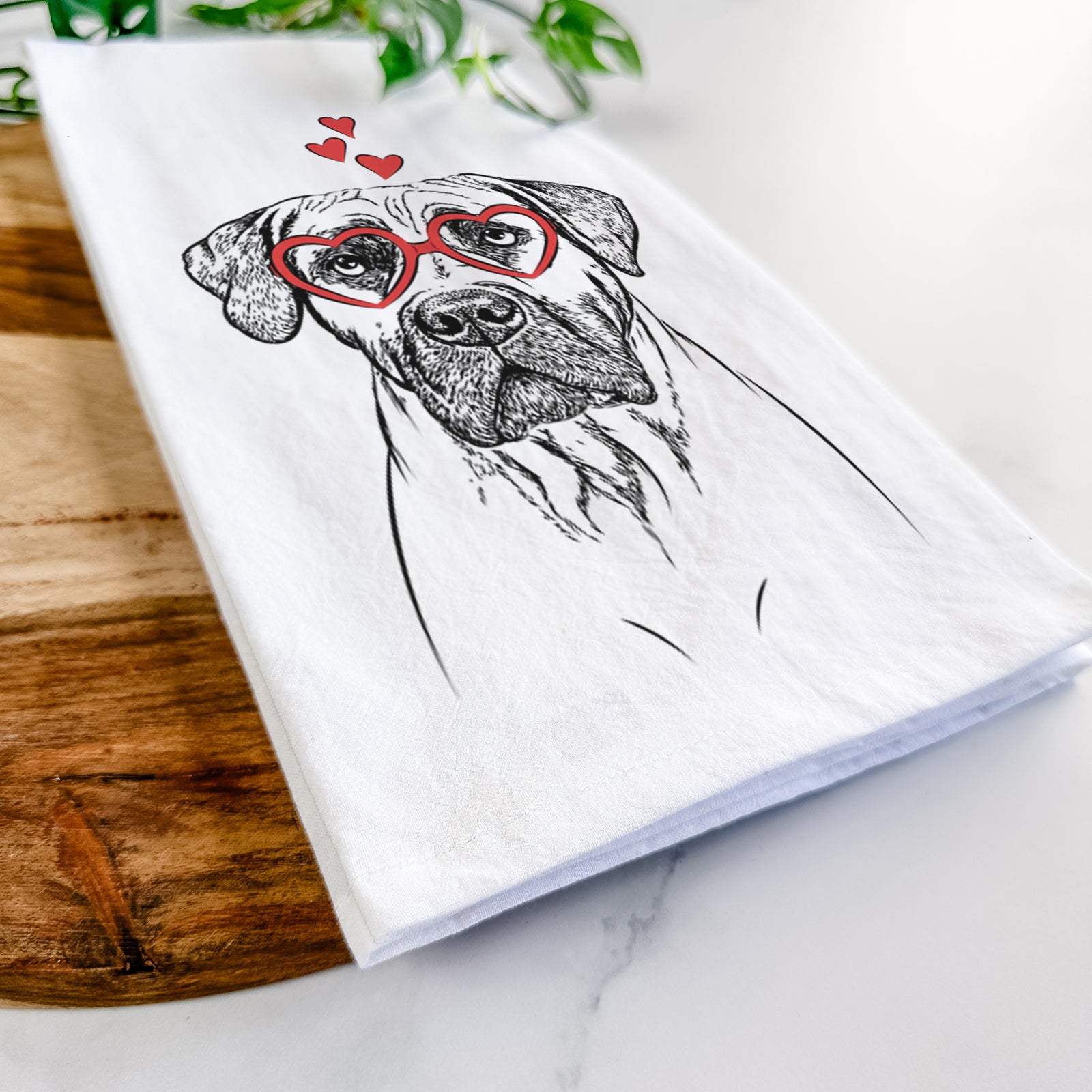 Hand-drawn sketch of Boris the Boerboel wearing heart-shaped glasses on a tea towel