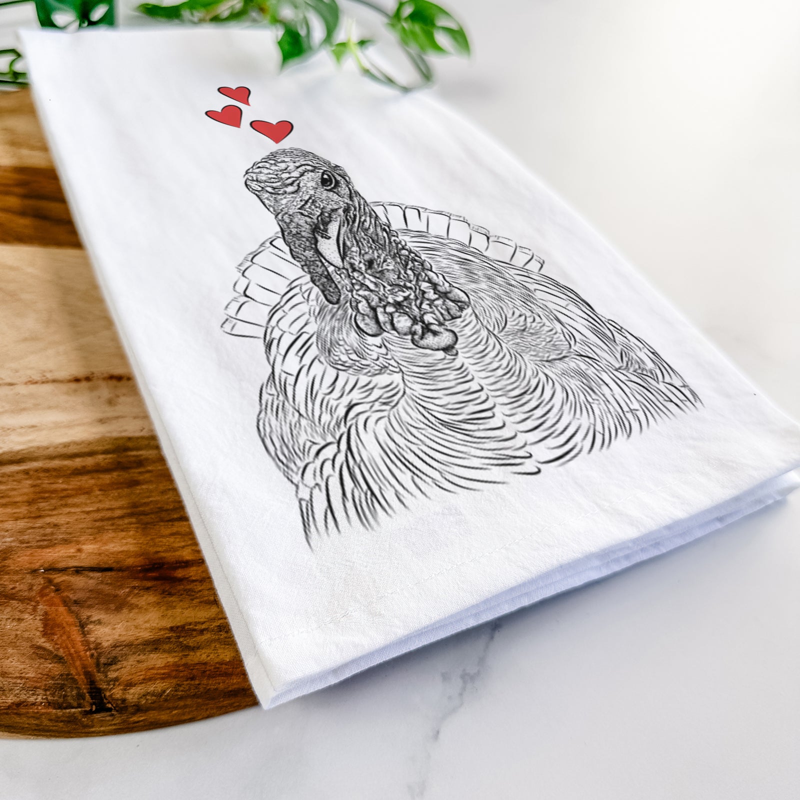 Hand-drawn sketch of Brady the Turkey wearing heart-shaped glasses on a tea towel