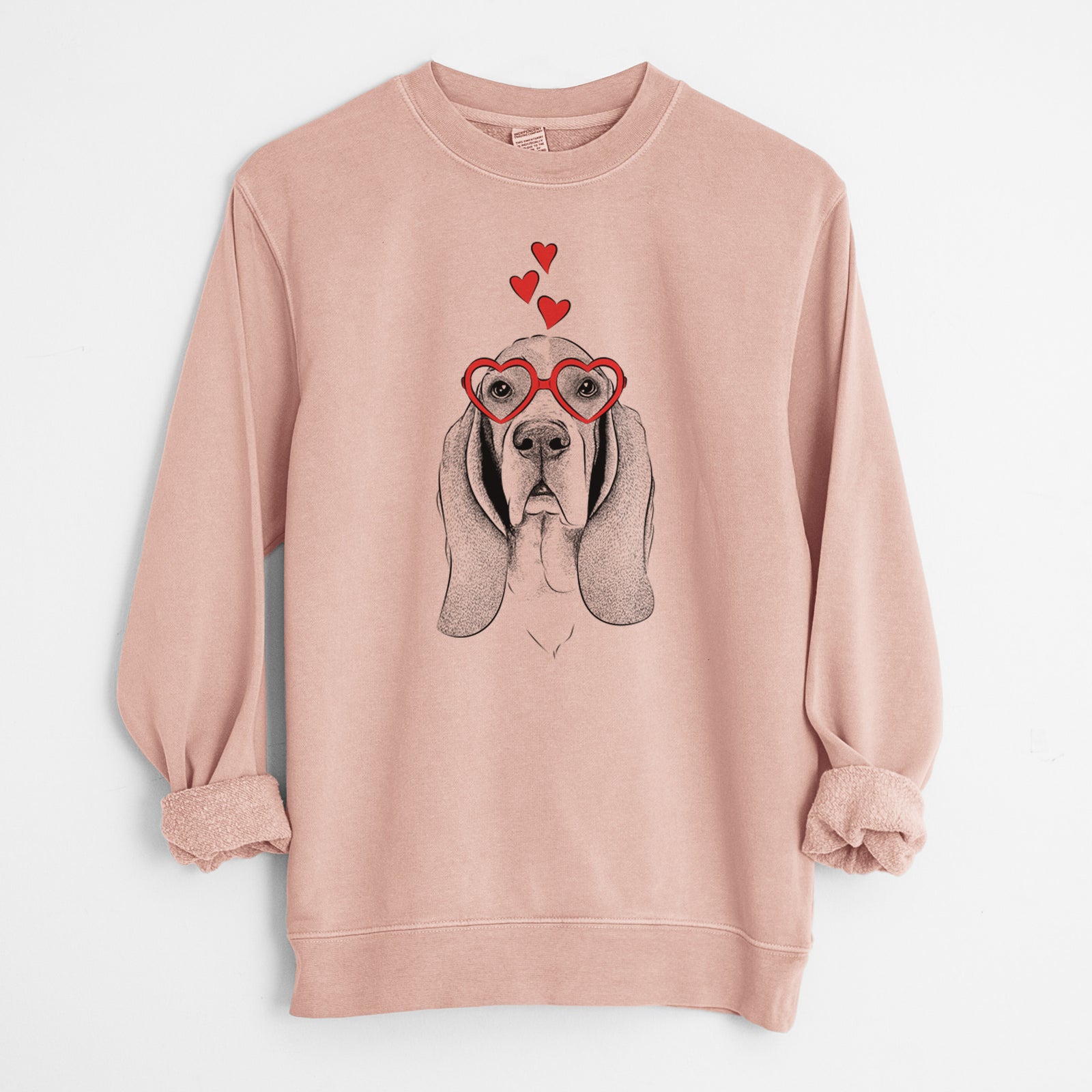 Hand-drawn sketch of Buckley the Basset Hound wearing heart-shaped glasses on a Dusty Pink Unisex pigment dyed crew sweatshirt