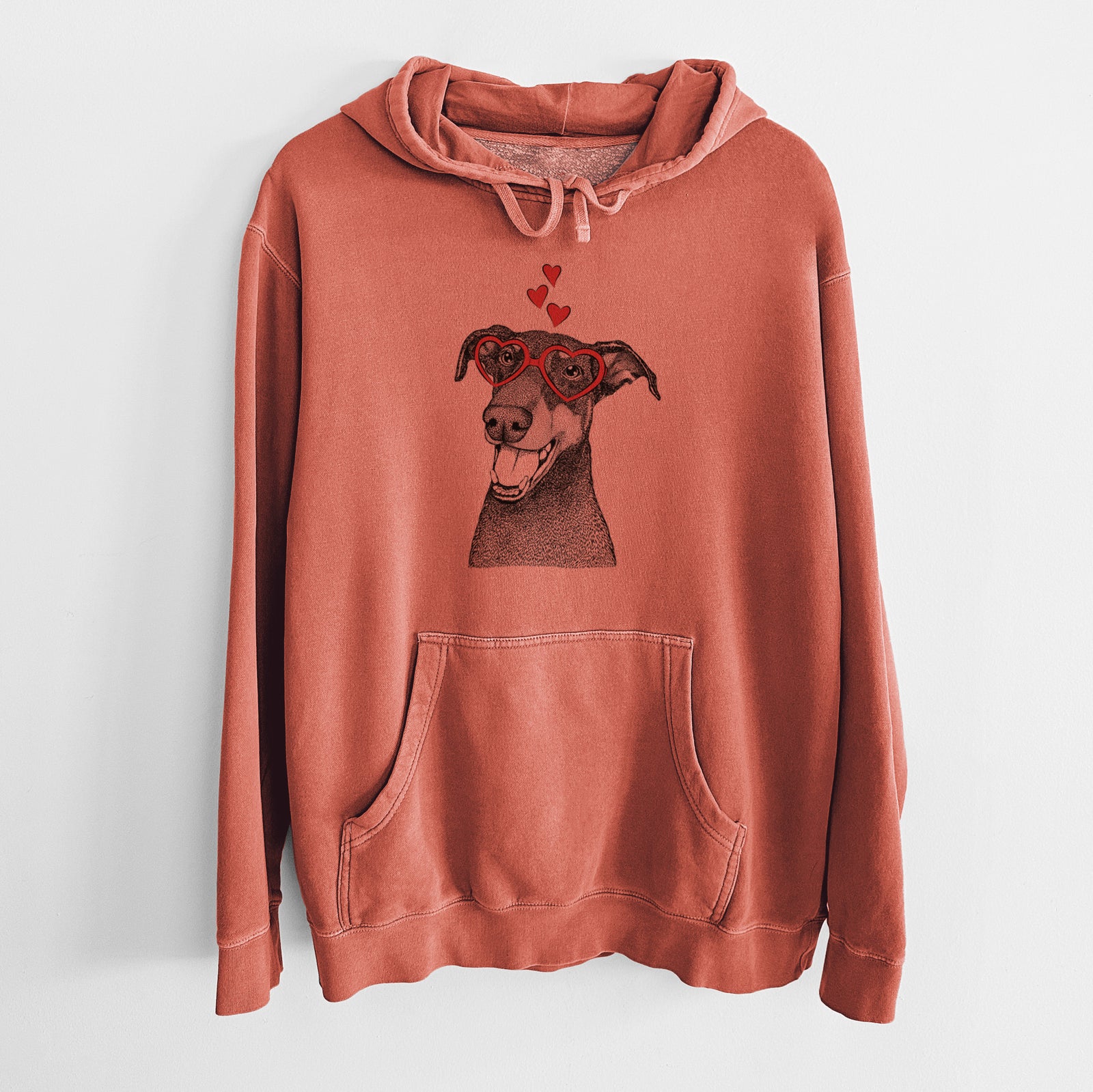 Hand-drawn sketch of Bunnie the Doberman Pinscher wearing heart-shaped glasses on an Amber Unisex pigment dyed hoodie
