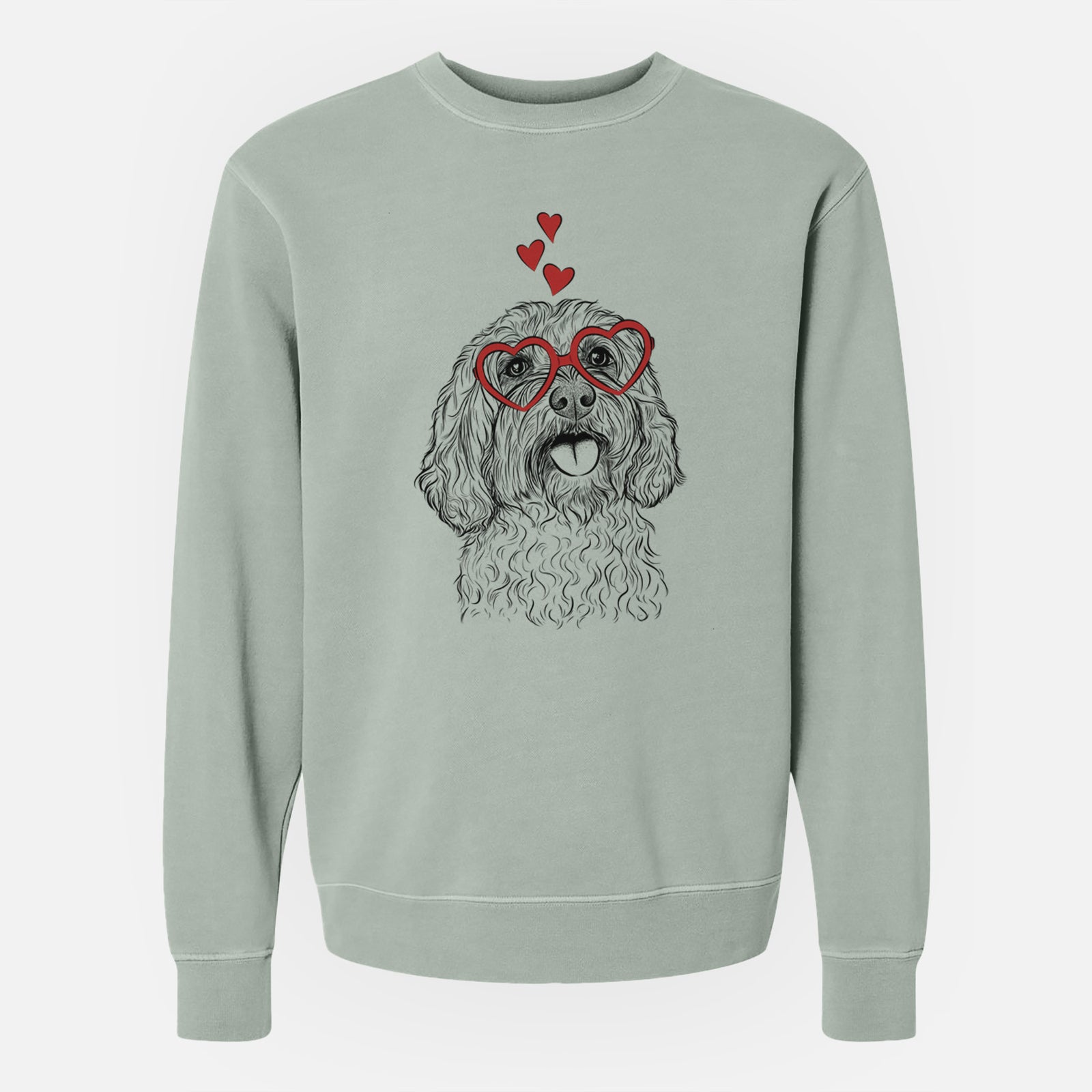 Hand-drawn sketch of Cali the Cavapoo wearing heart-shaped glasses on a Sage Unisex pigment dyed crew sweatshirt
