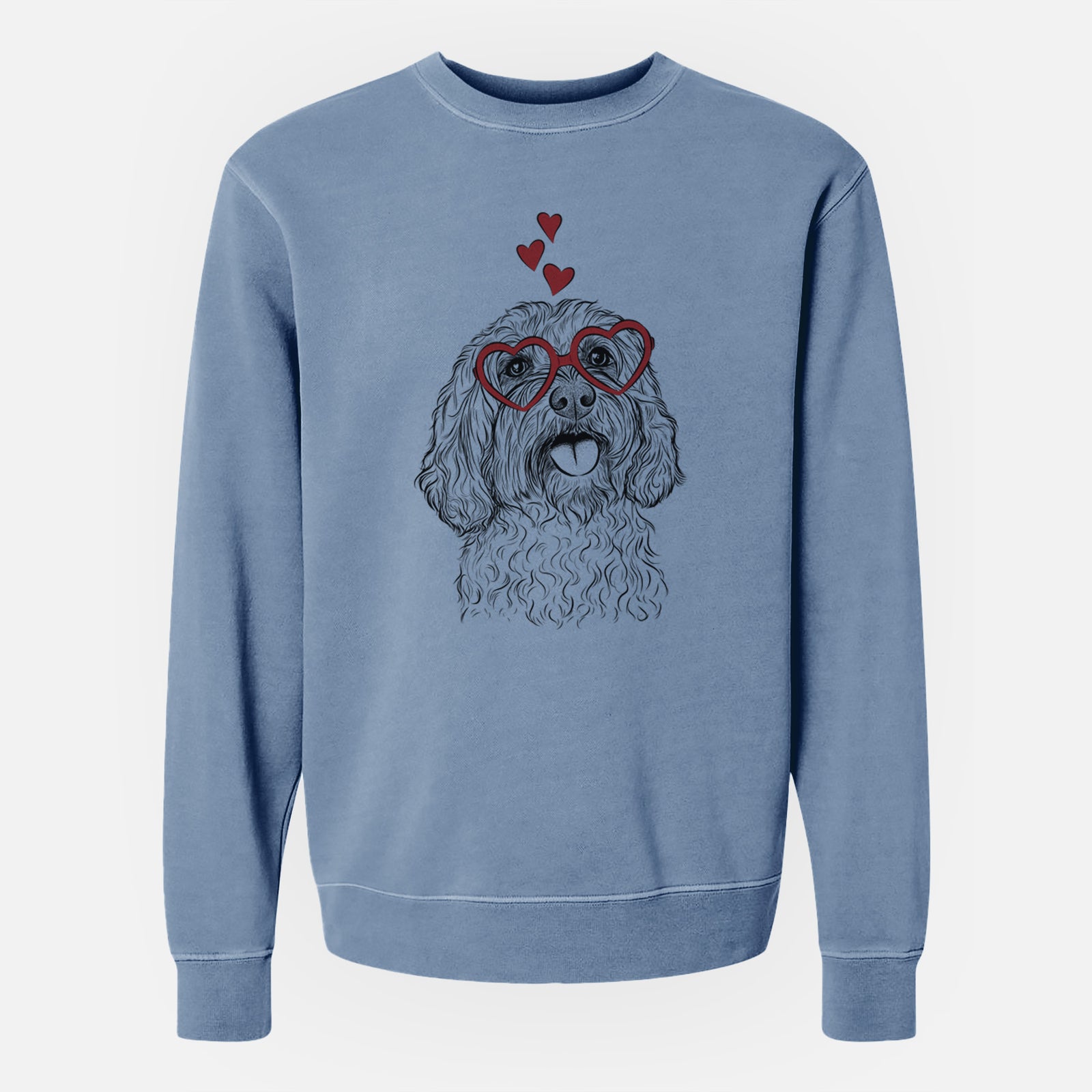 Hand-drawn sketch of Cali the Cavapoo wearing heart-shaped glasses on a Slate Blue Unisex pigment dyed crew sweatshirt