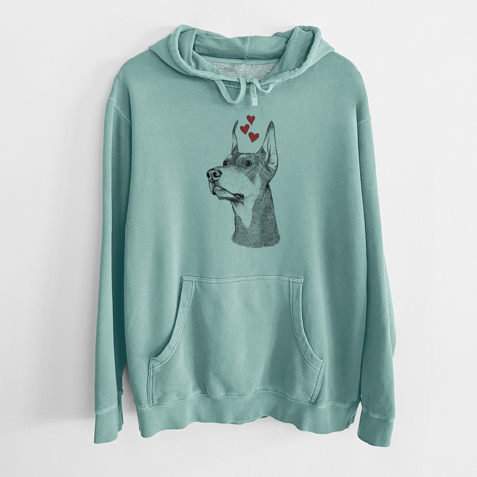 Hand-drawn sketch of Cenza the Doberman Pinscher wearing heart-shaped glasses on a Mint Unisex pigment dyed hoodie
