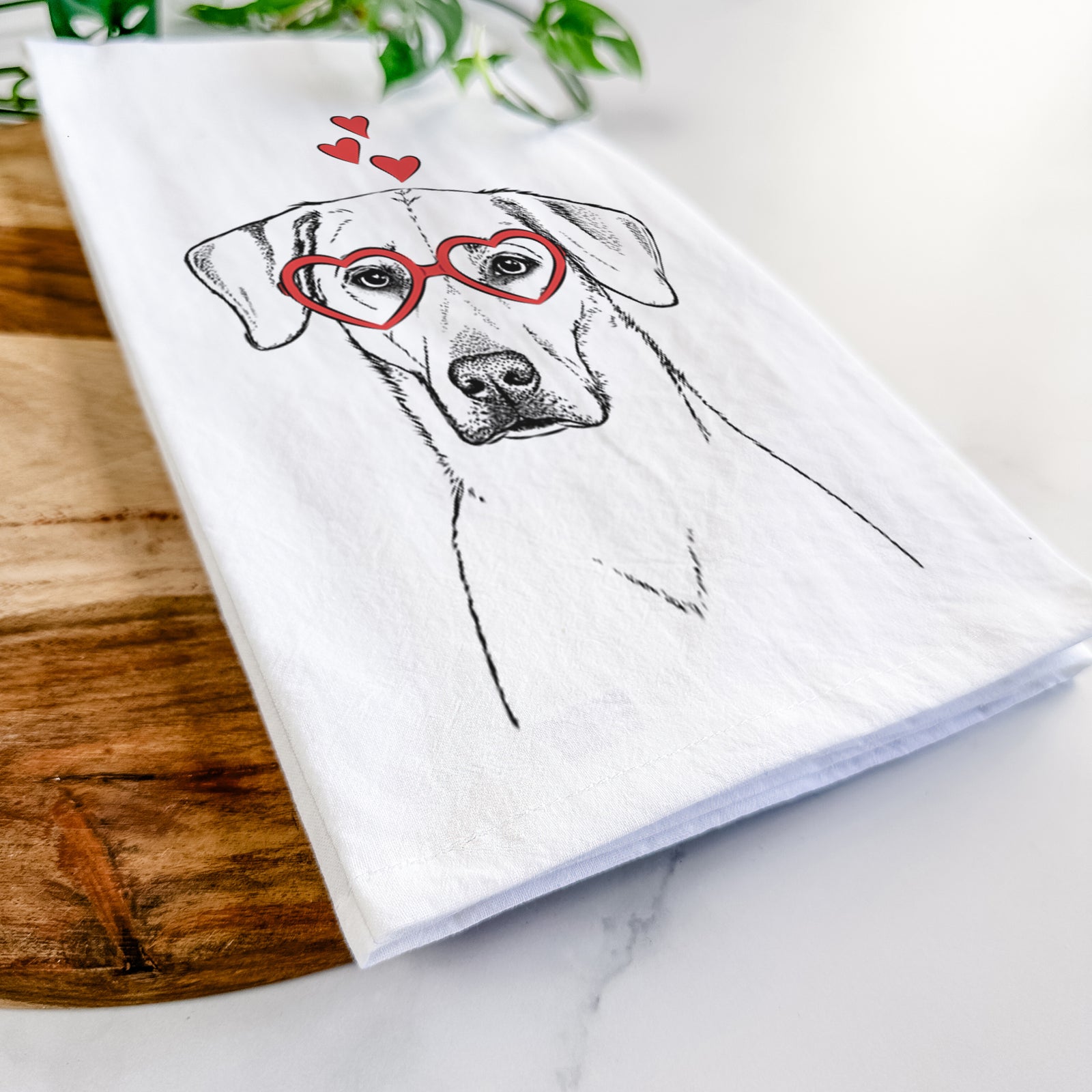 Hand-drawn sketch of Charlie Girl the Yellow Lab wearing heart-shaped glasses on a tea towel