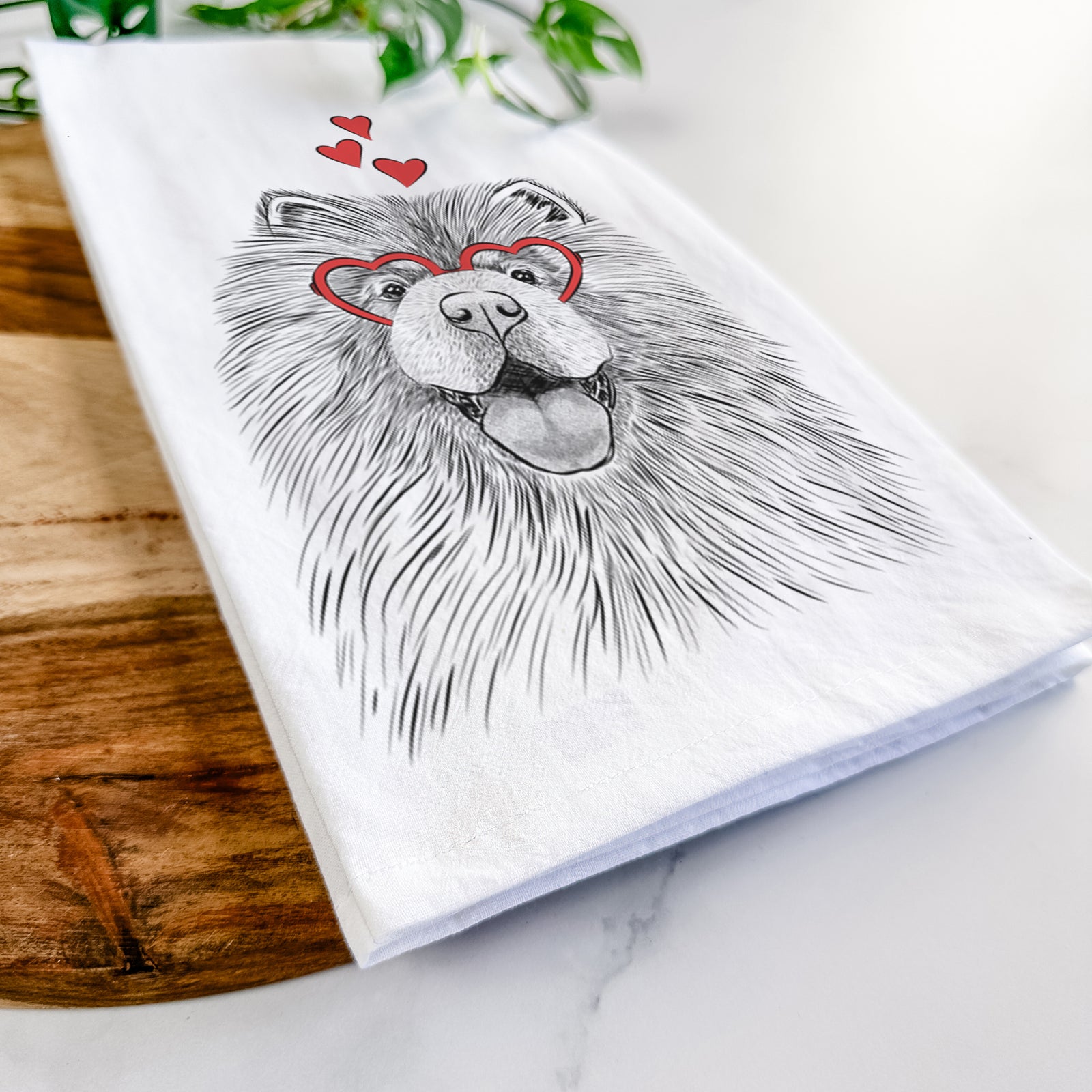Hand-drawn sketch of Charming Charlie the Chow Chow wearing heart-shaped glasses on a tea towel