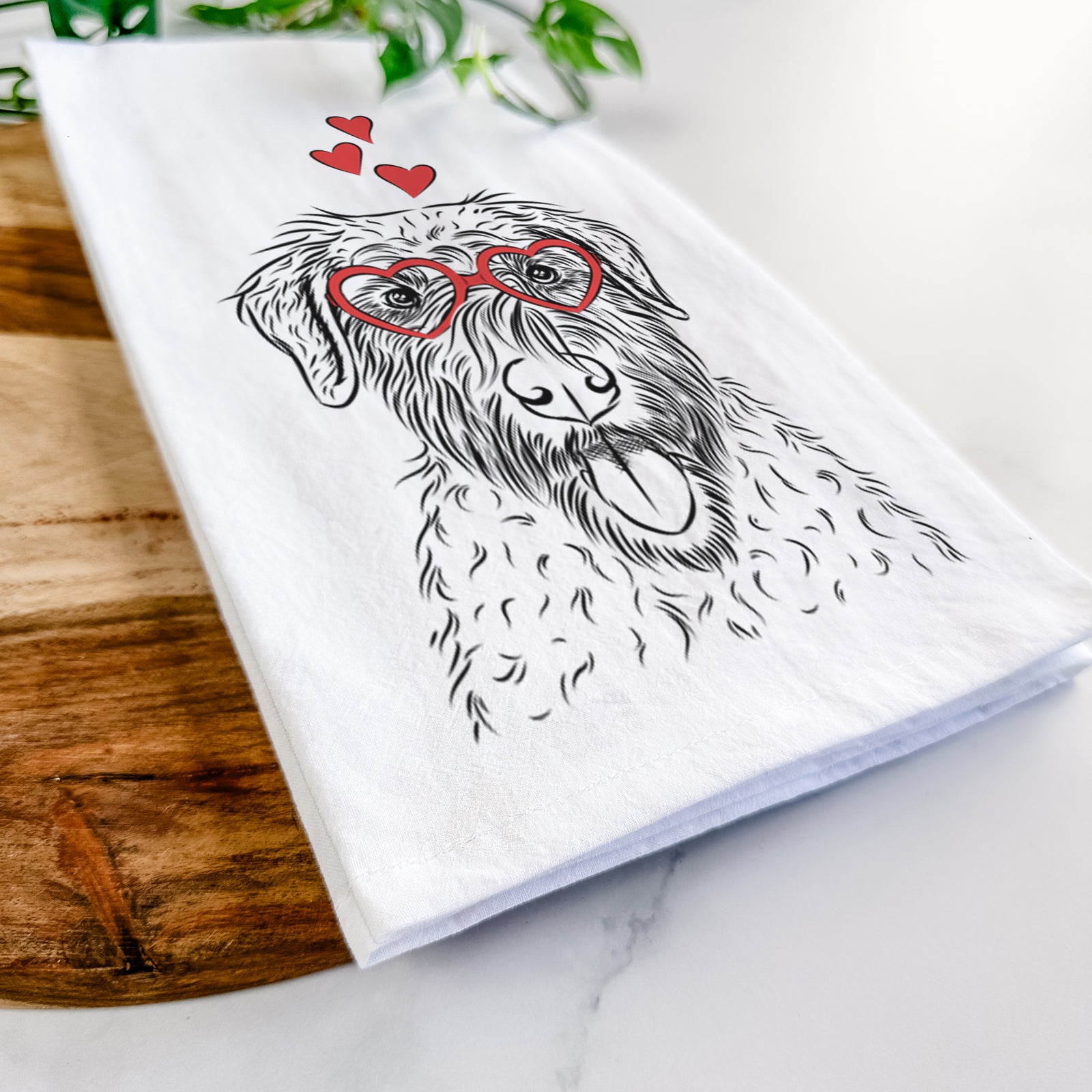 Hand-drawn sketch of Chester the Soft Coated Wheaten Terrier wearing heart-shaped glasses on a tea towel