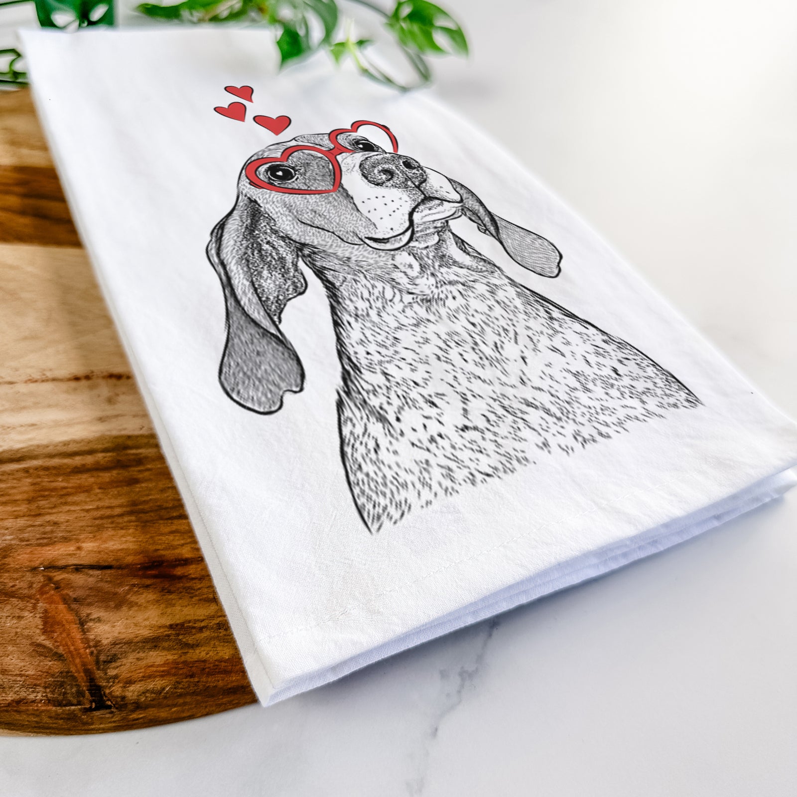 Hand-drawn sketch of Chester the Red Tick Coonhound wearing heart-shaped glasses on a tea towel
