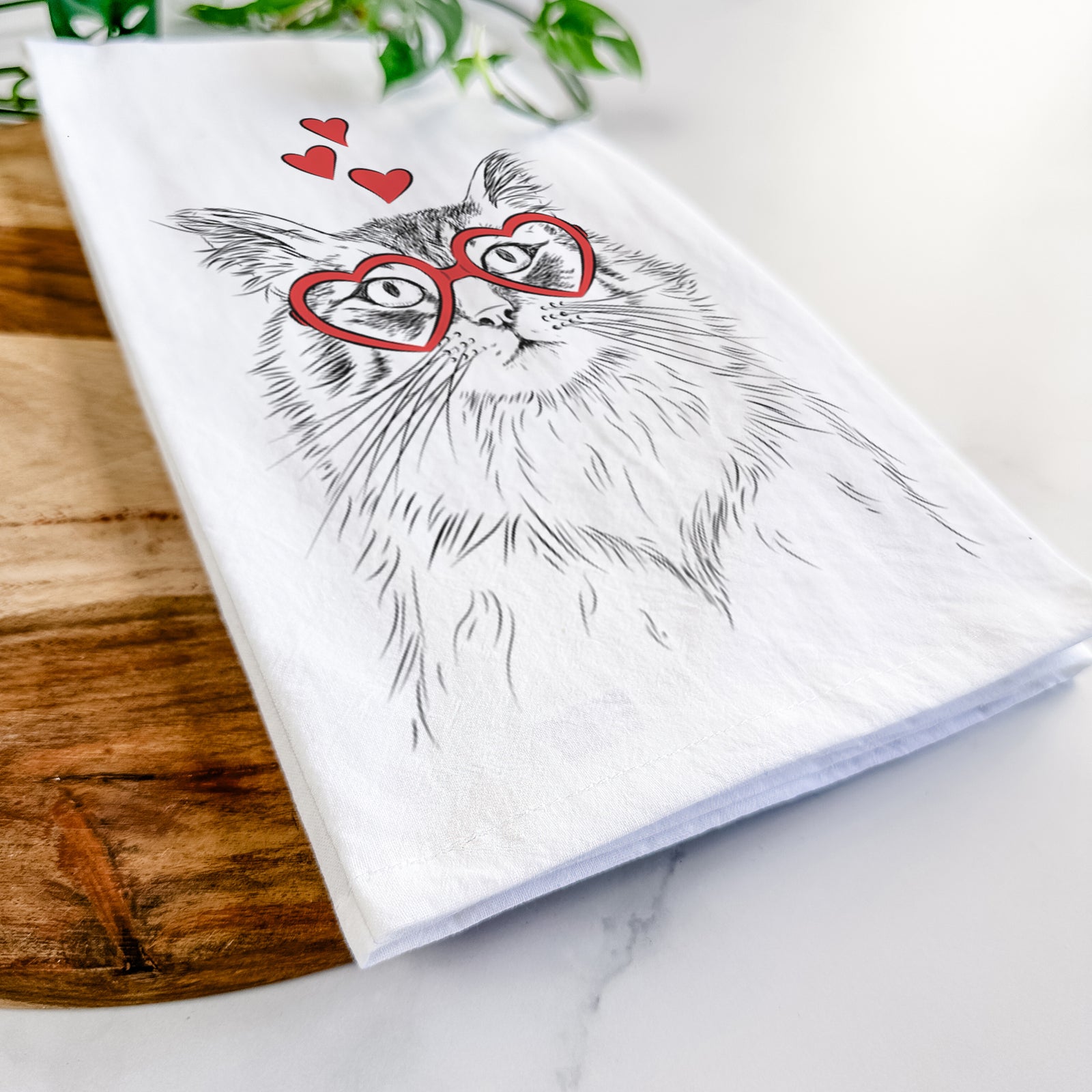 Hand-drawn sketch of Chloe the Tabby Cat wearing heart-shaped glasses on a tea towel