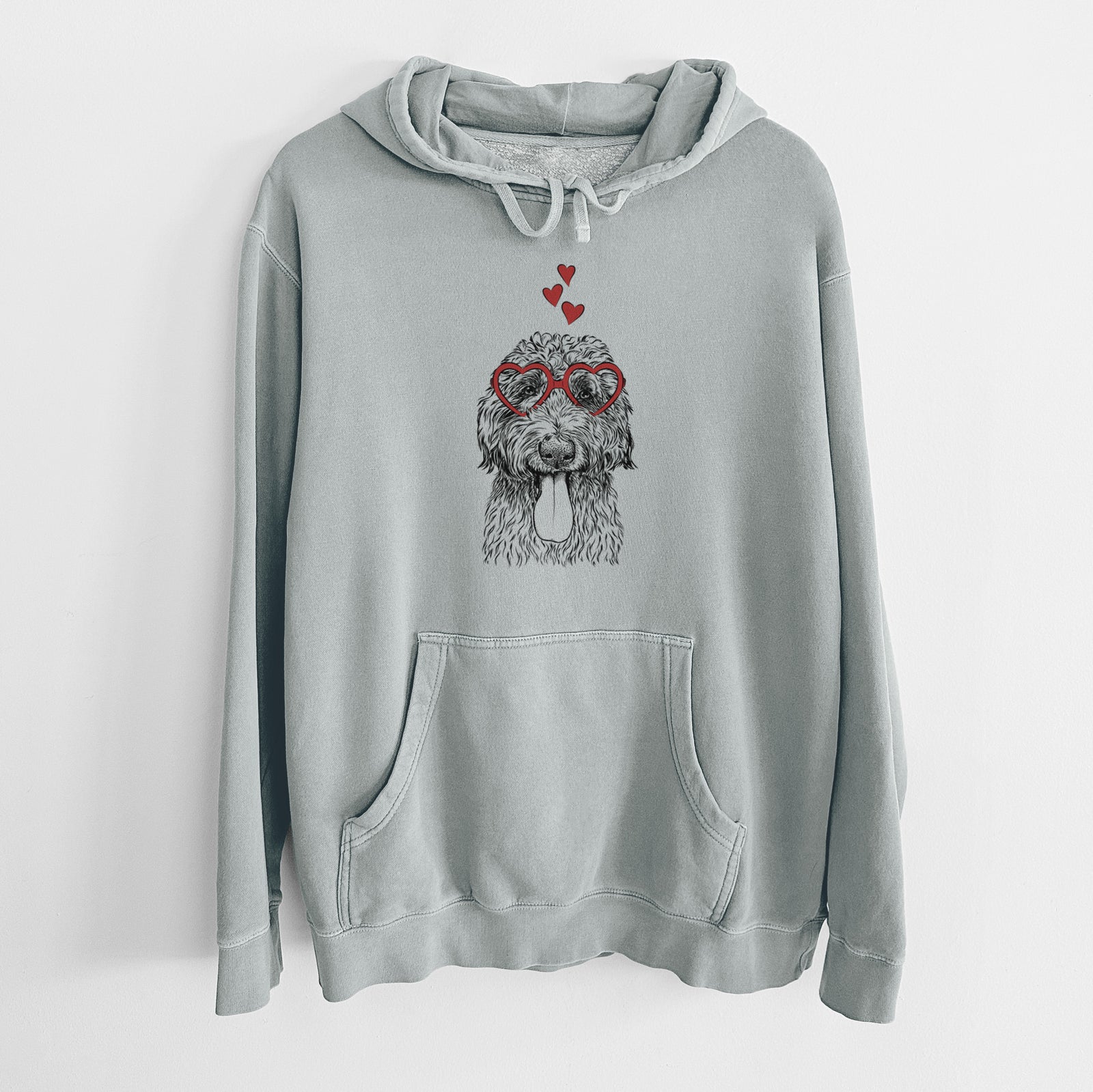 Hand-drawn sketch of CiCi Paulk the Aussiedoodle wearing heart-shaped glasses on a Sage Unisex pigment dyed hoodie