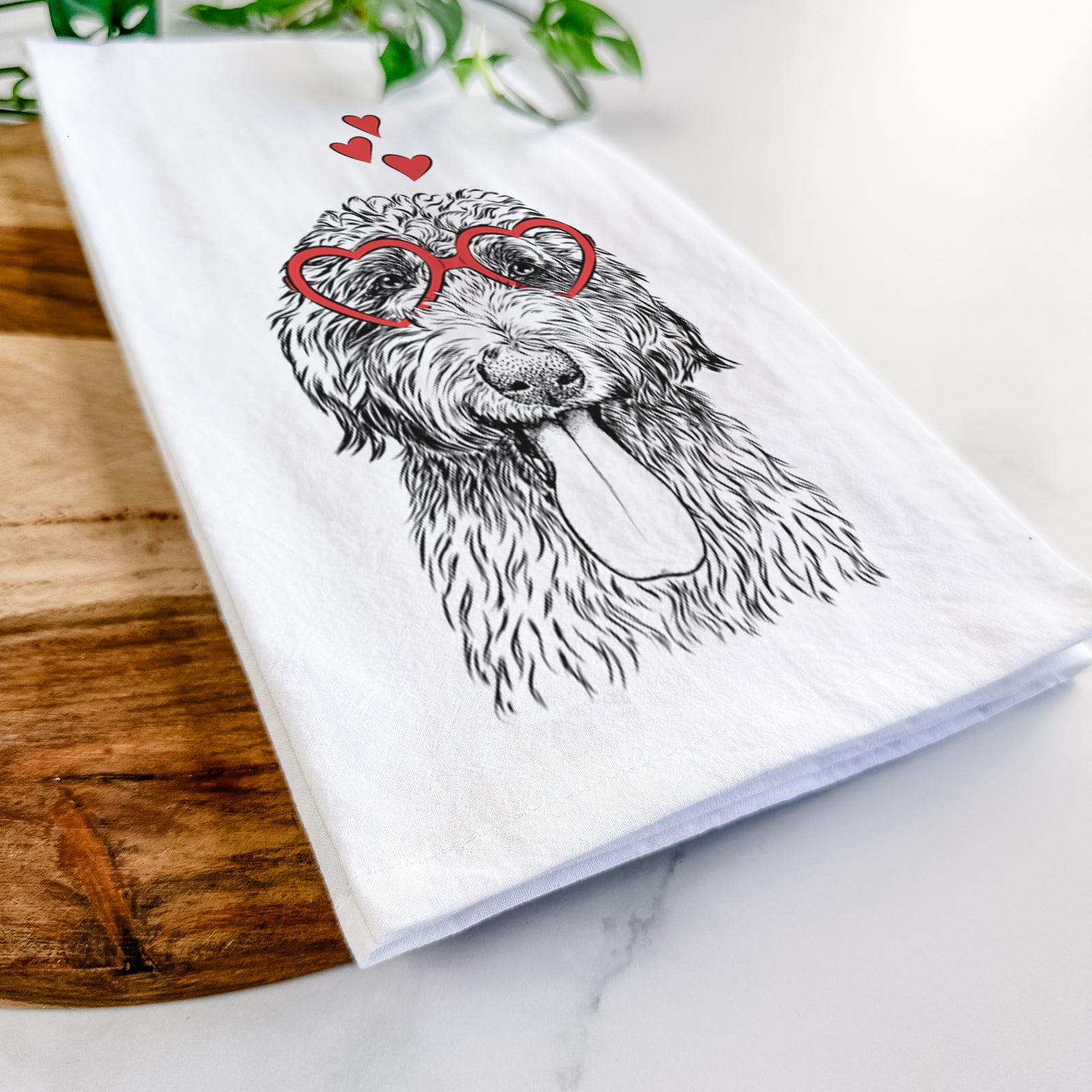 Hand-drawn sketch of CiCi Paulk the Aussiedoodle wearing heart-shaped glasses on a tea towel