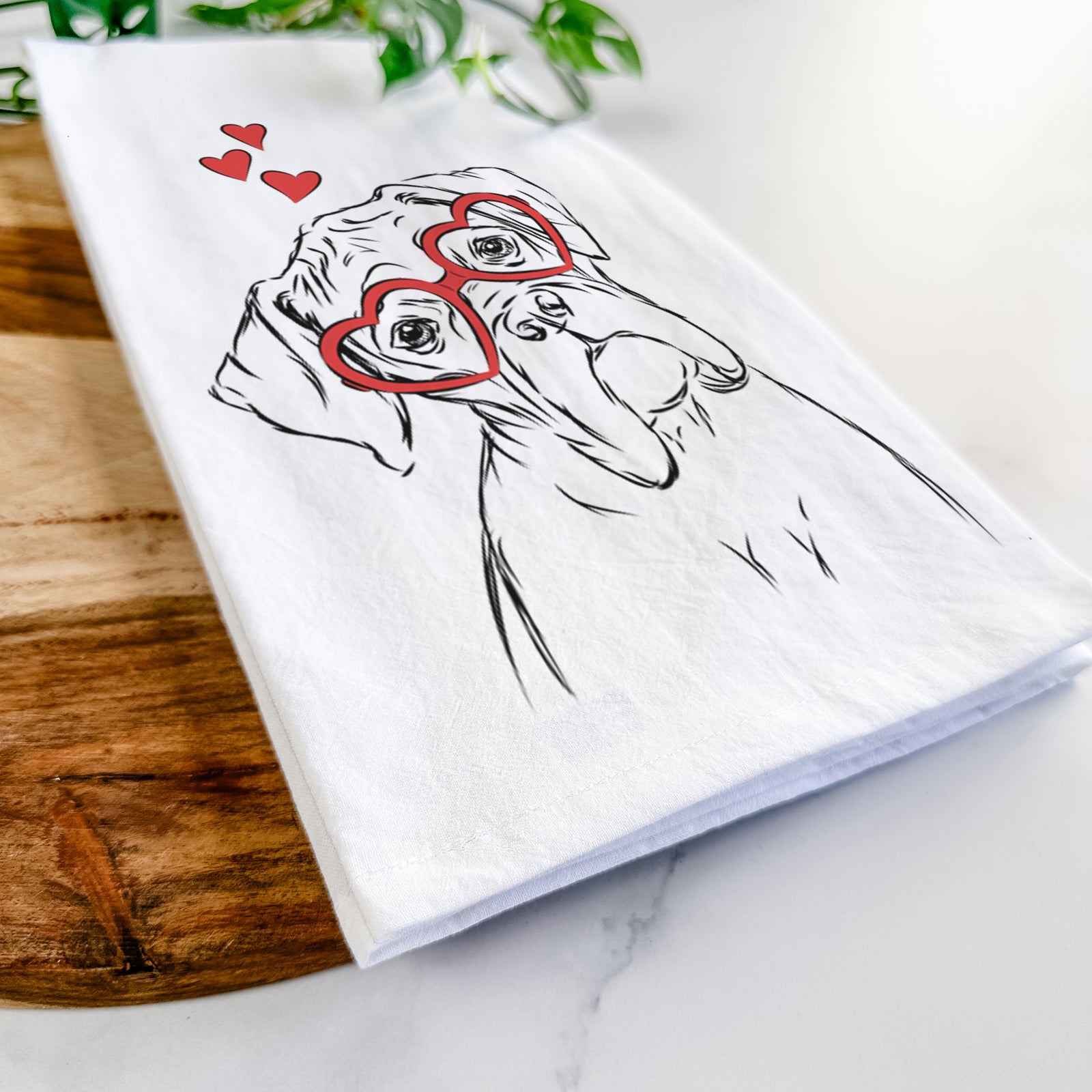 Hand-drawn sketch of Cooper the Boxer wearing heart-shaped glasses on a tea towel