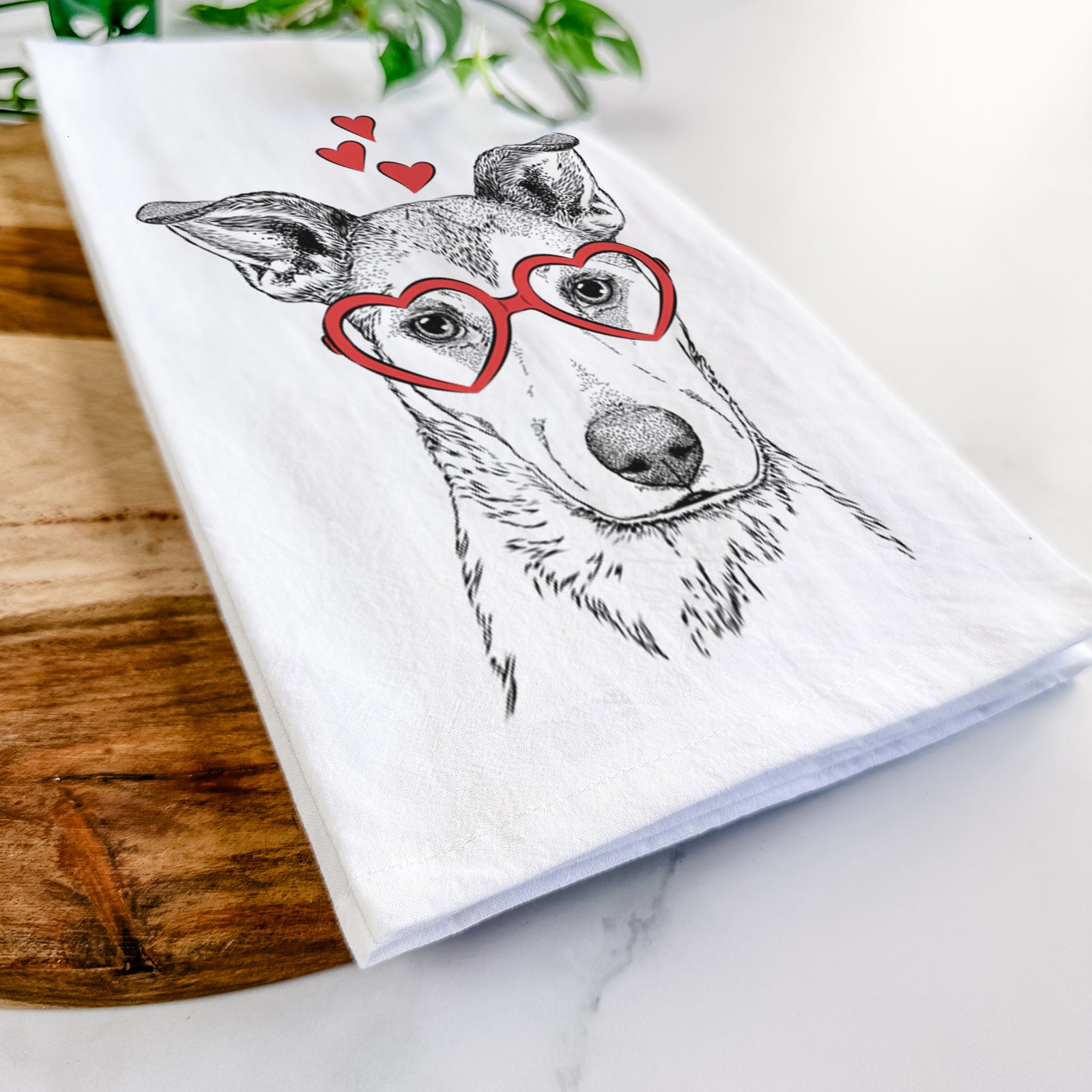 Hand-drawn sketch of Coral the Mixed Breed wearing heart-shaped glasses on a tea towel