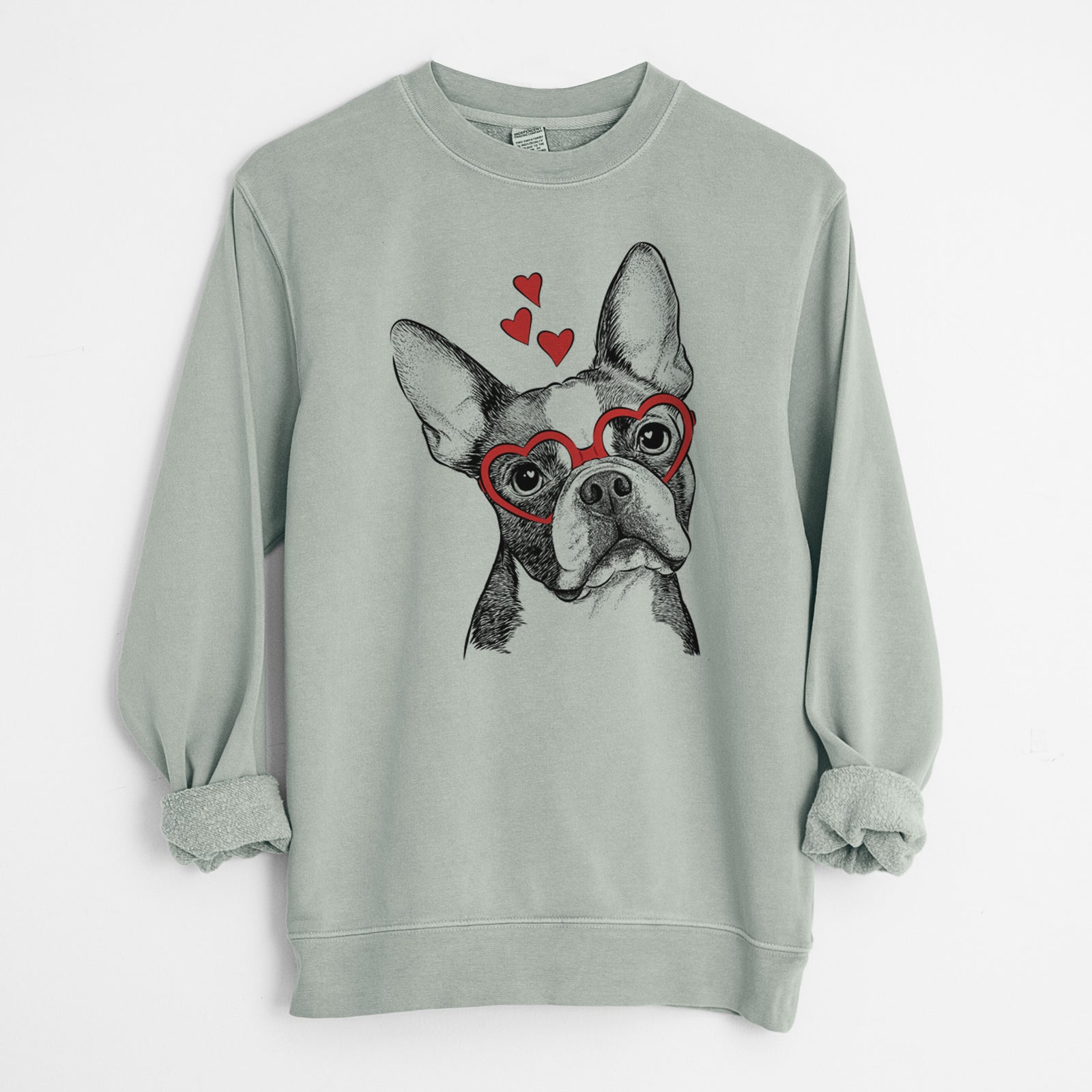 Hand-drawn sketch of Dee Dee the Boston Terrier wearing heart-shaped glasses on a Sage Unisex pigment dyed crew sweatshirt