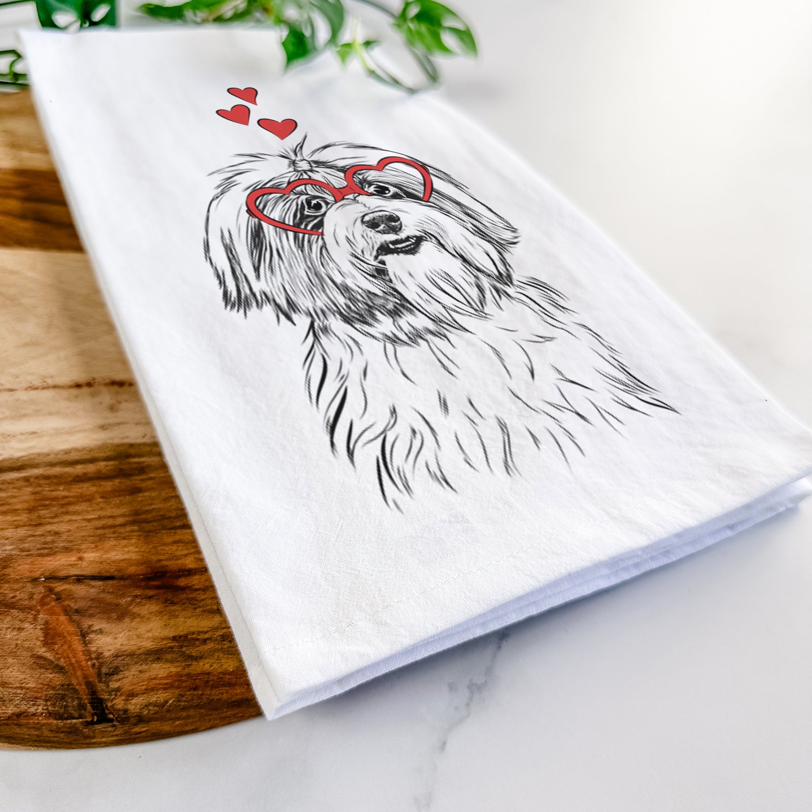 Hand-drawn sketch of Dooley the Havanese wearing heart-shaped glasses on a tea towel