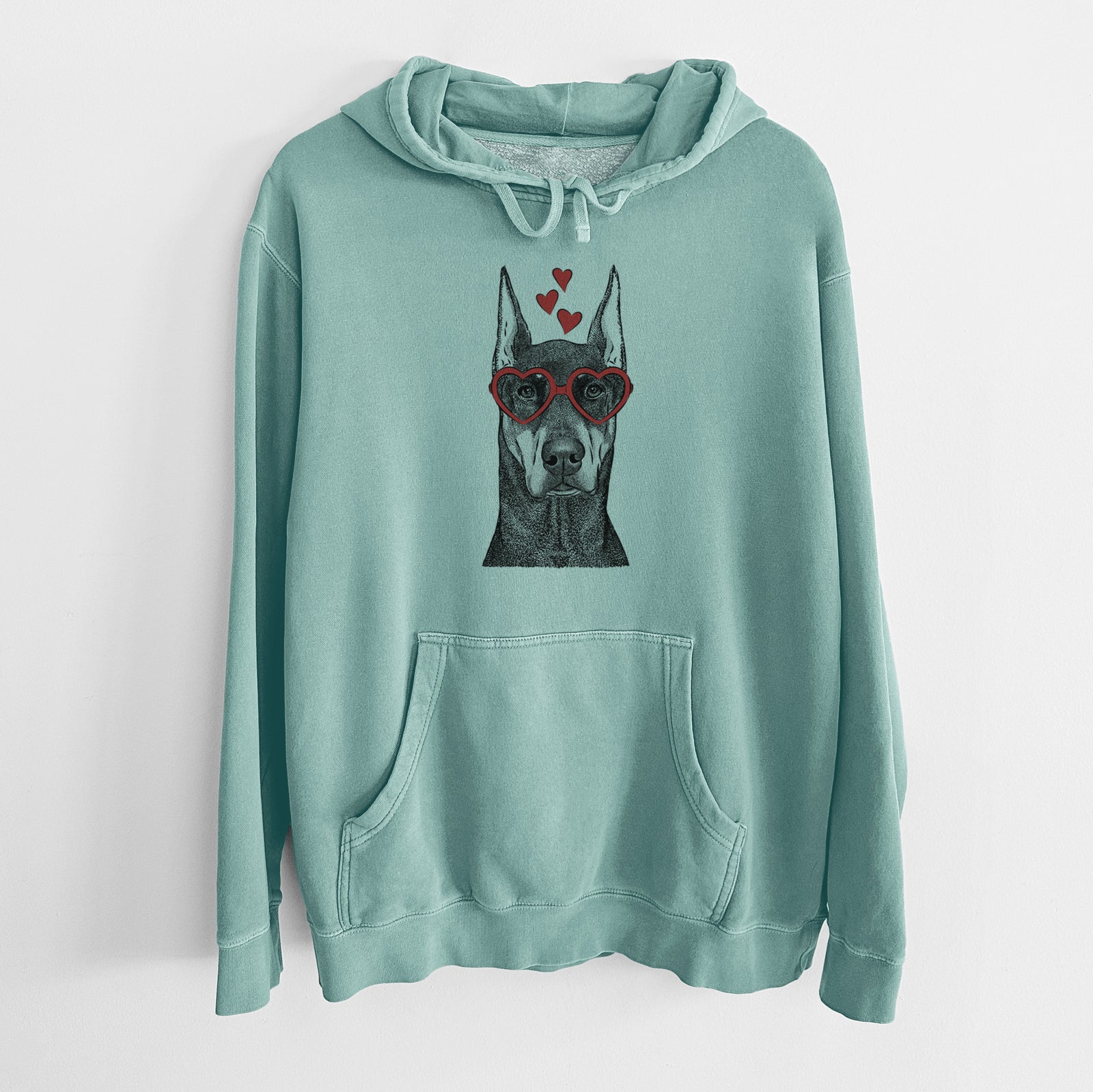 Hand-drawn sketch of Drake the Doberman Pinscher wearing heart-shaped glasses on a Mint Unisex pigment dyed hoodie