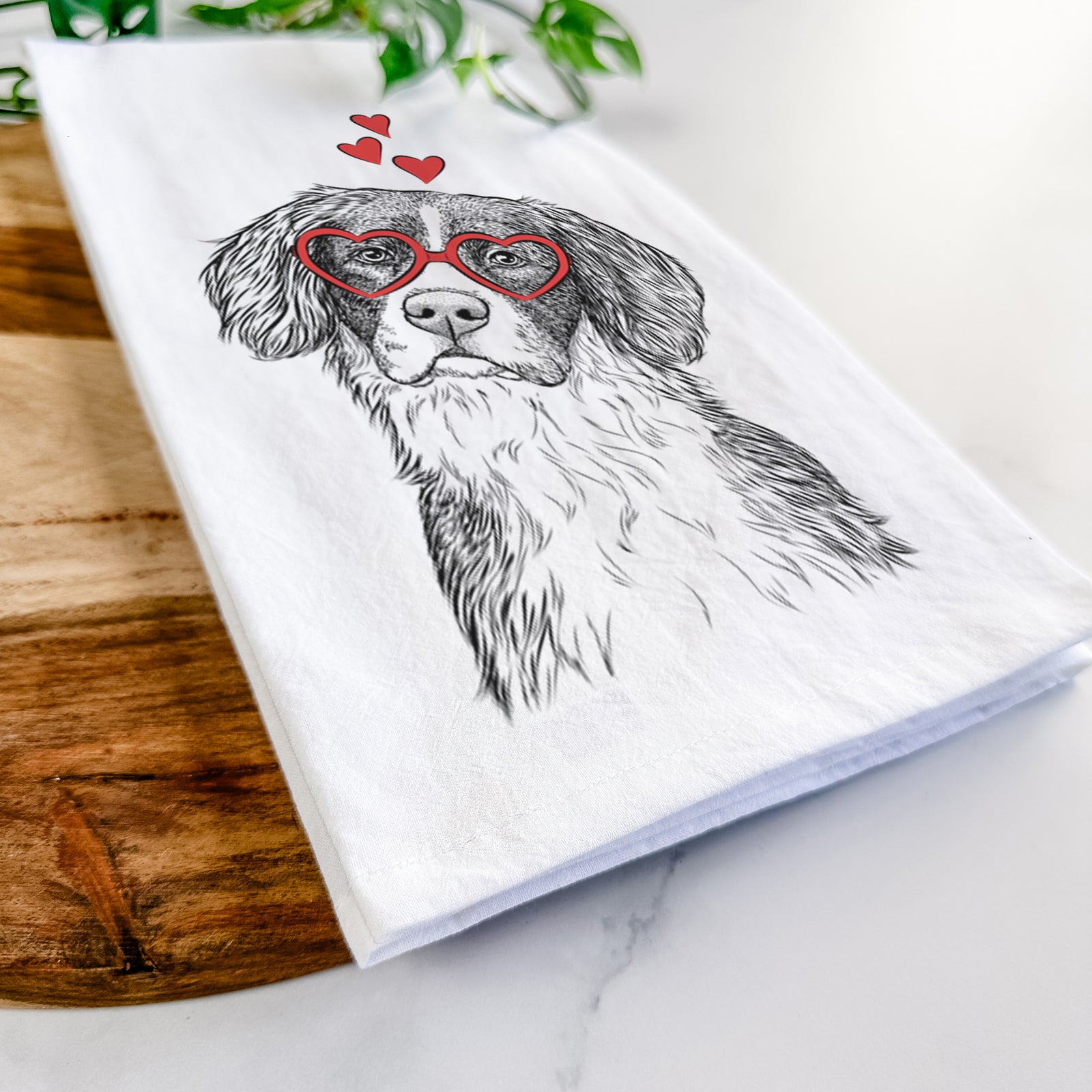 Hand-drawn sketch of Dulce the Drentsche Patrijshond wearing heart-shaped glasses on a tea towel