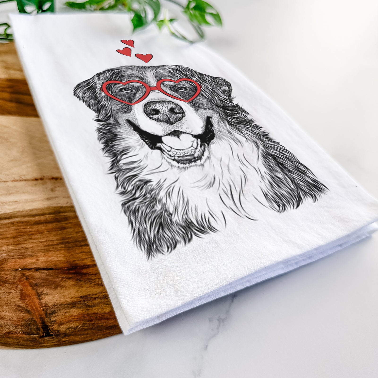 Hand-drawn sketch of Eiger the Bernese Mountain Dog wearing heart-shaped glasses on a tea towel