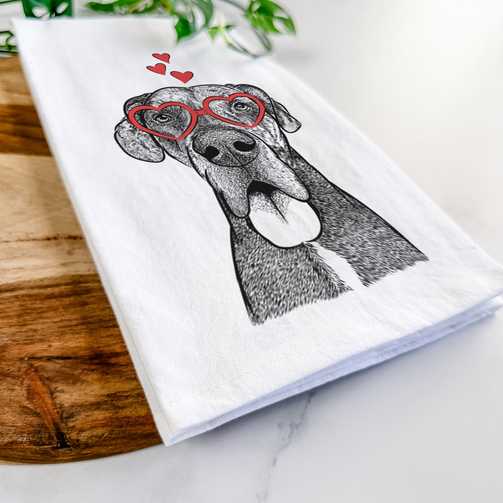 Hand-drawn sketch of Eli the Great Dane wearing heart-shaped glasses on a tea towel