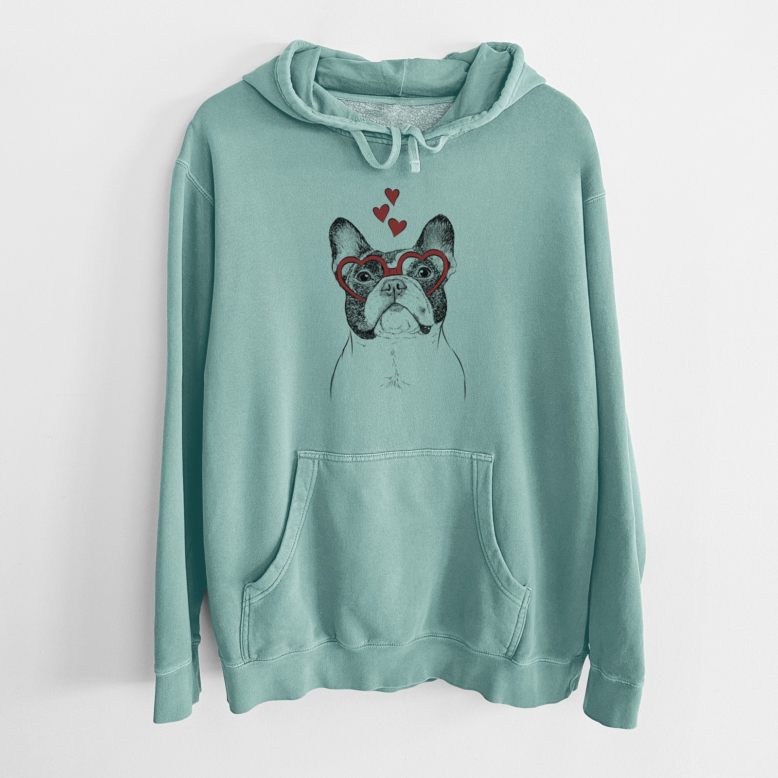 Hand-drawn sketch of Ella the French Bulldog wearing heart-shaped glasses on a Mint Unisex pigment dyed hoodie