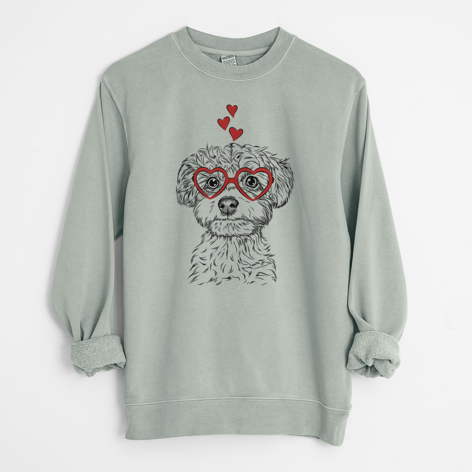 Hand-drawn sketch of Elliott the Yorkiepoo wearing heart-shaped glasses on a Sage Unisex pigment dyed crew sweatshirt