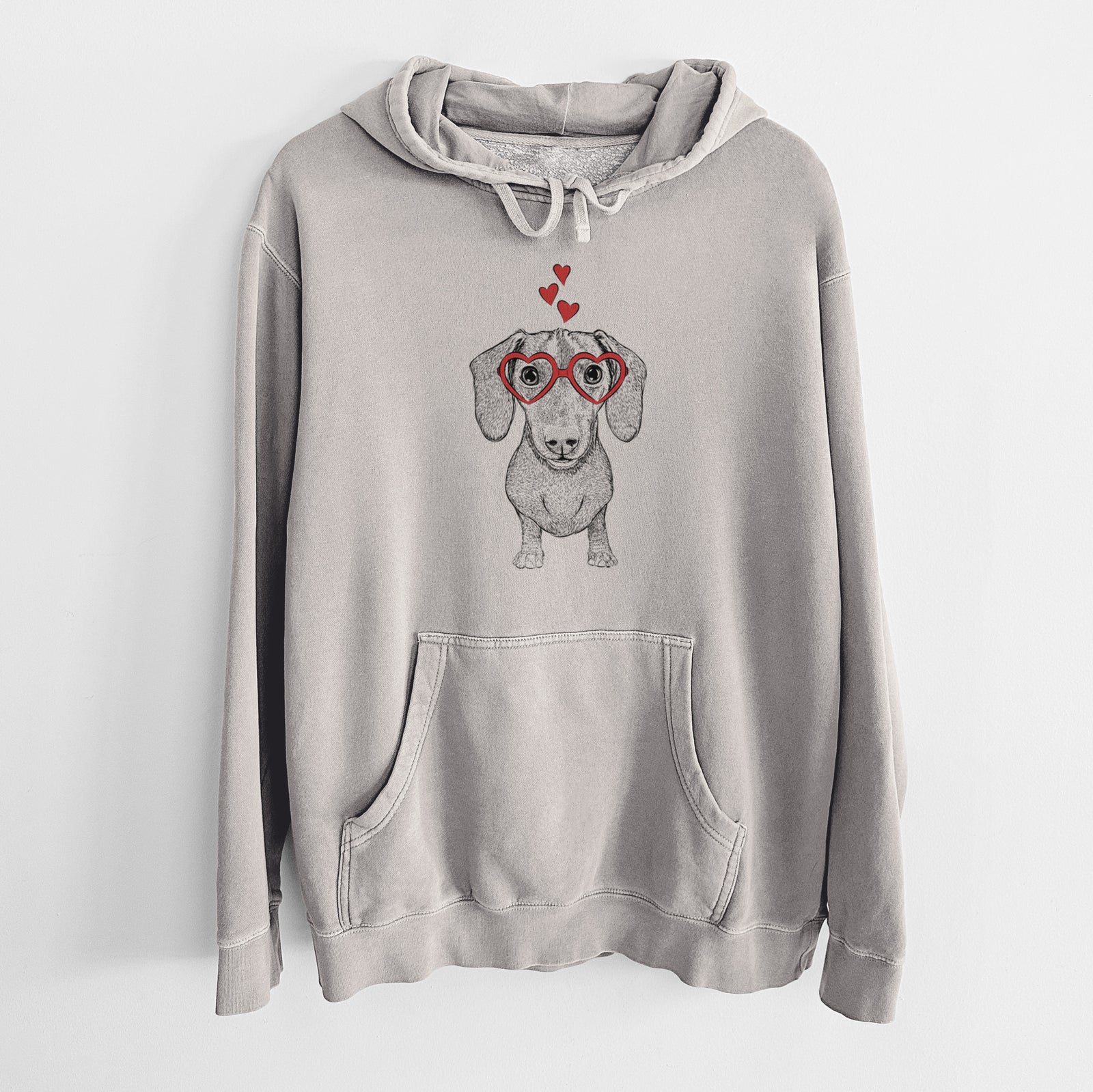 Hand-drawn sketch of Ernie the Mini Dachshund wearing heart-shaped glasses on a Cement Unisex pigment dyed hoodie