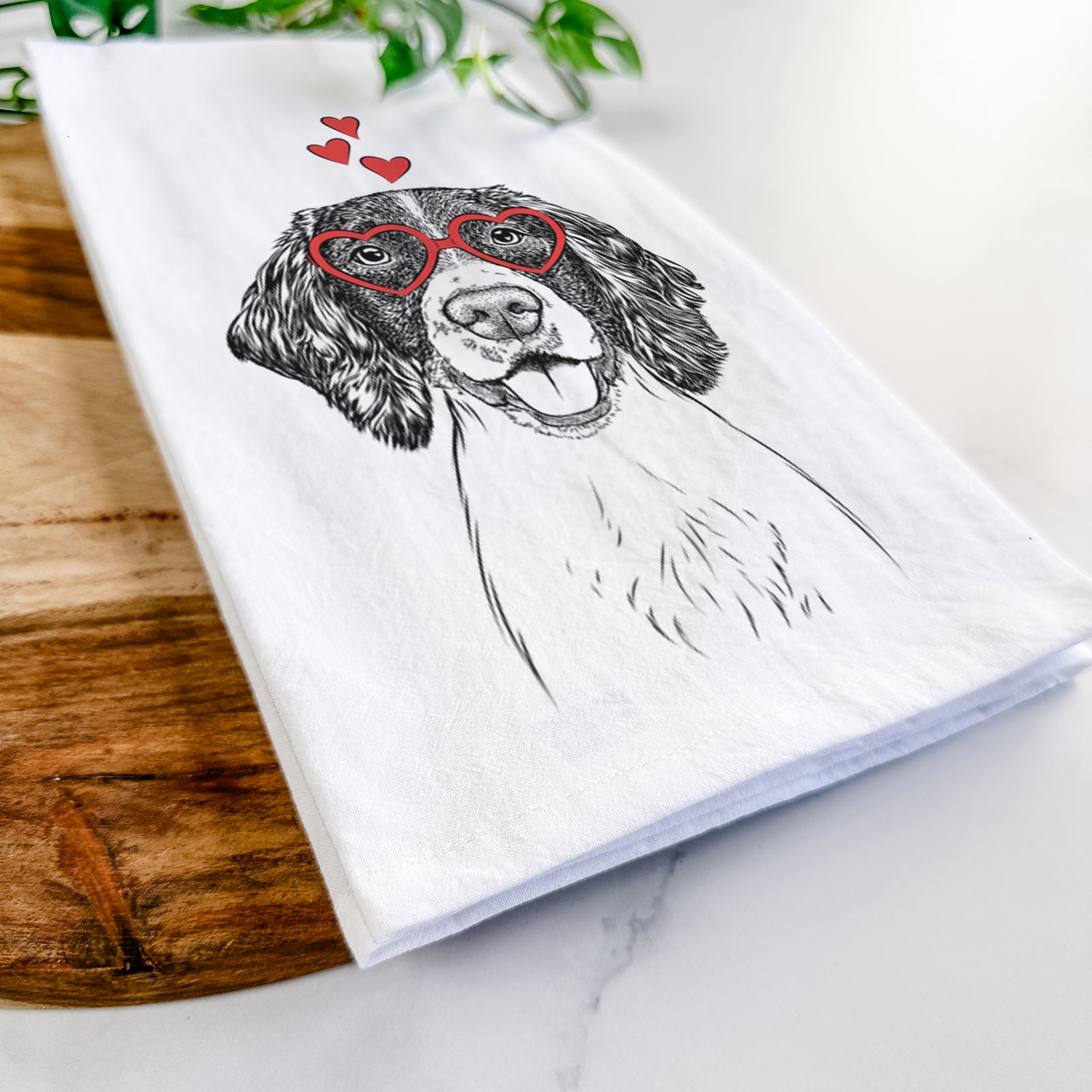 Hand-drawn sketch of Ever the English Springer Spaniel wearing heart-shaped glasses on a tea towel