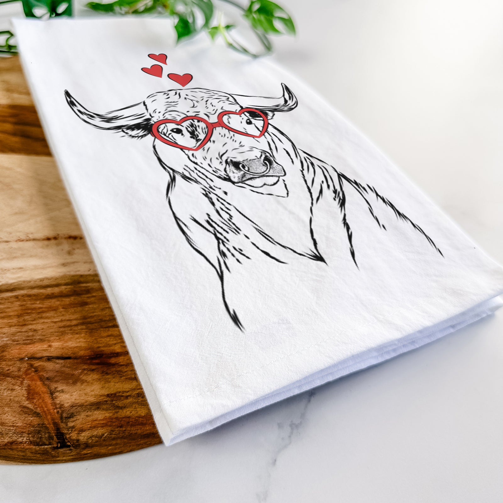 Hand-drawn sketch of Ferdinand the Bull wearing heart-shaped glasses on a tea towel
