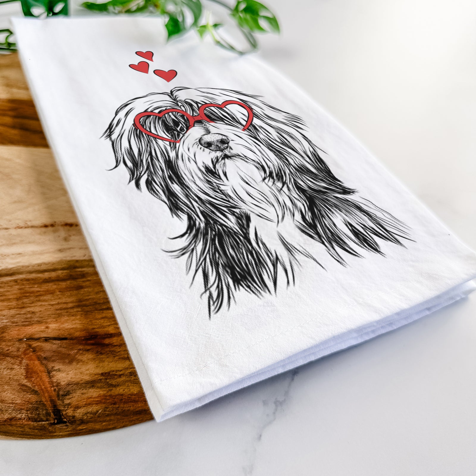 Hand-drawn sketch of Fiji the Polish Lowland Sheepdog wearing heart-shaped glasses on a tea towel