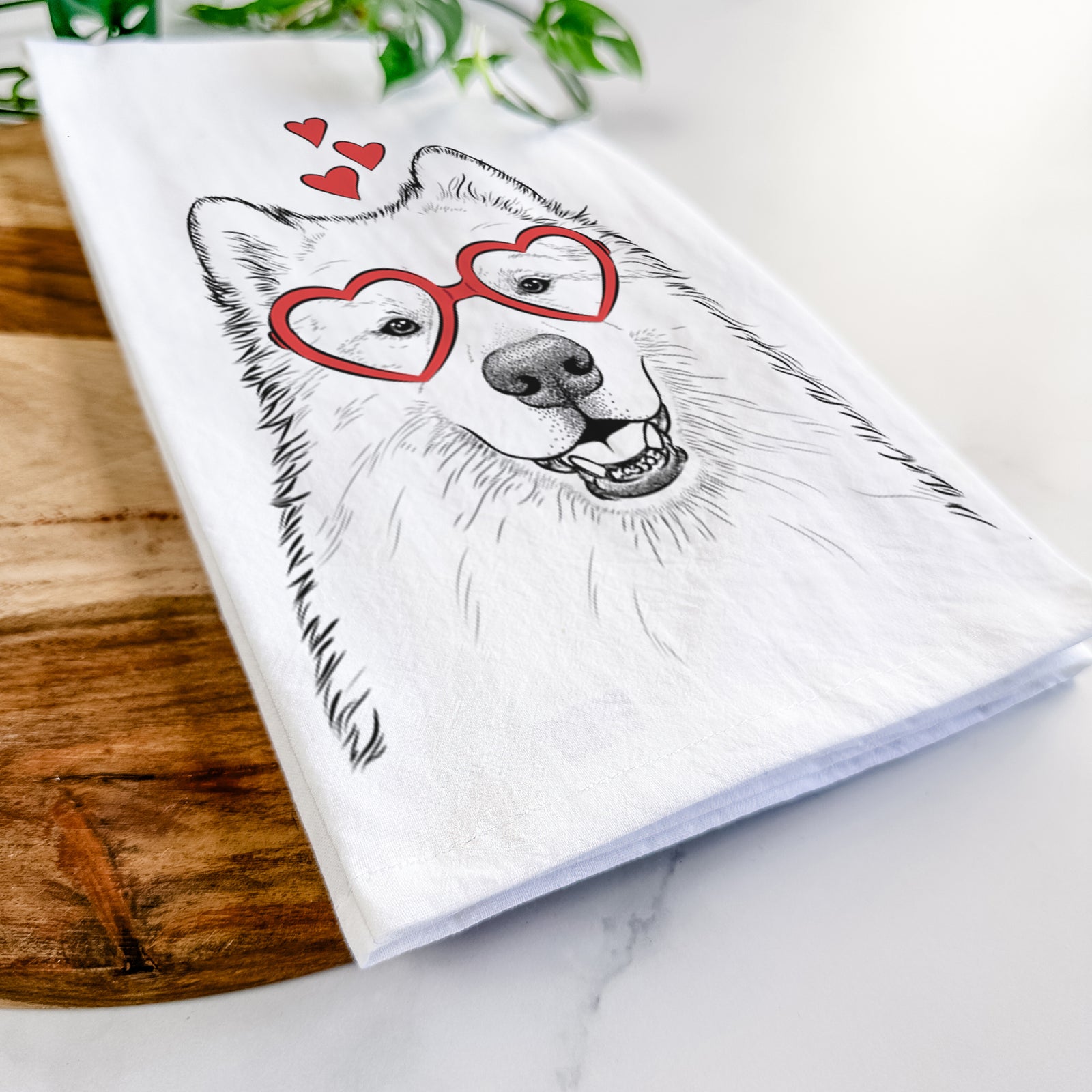 Hand-drawn sketch of Foster the Samoyed wearing heart-shaped glasses on a tea towel