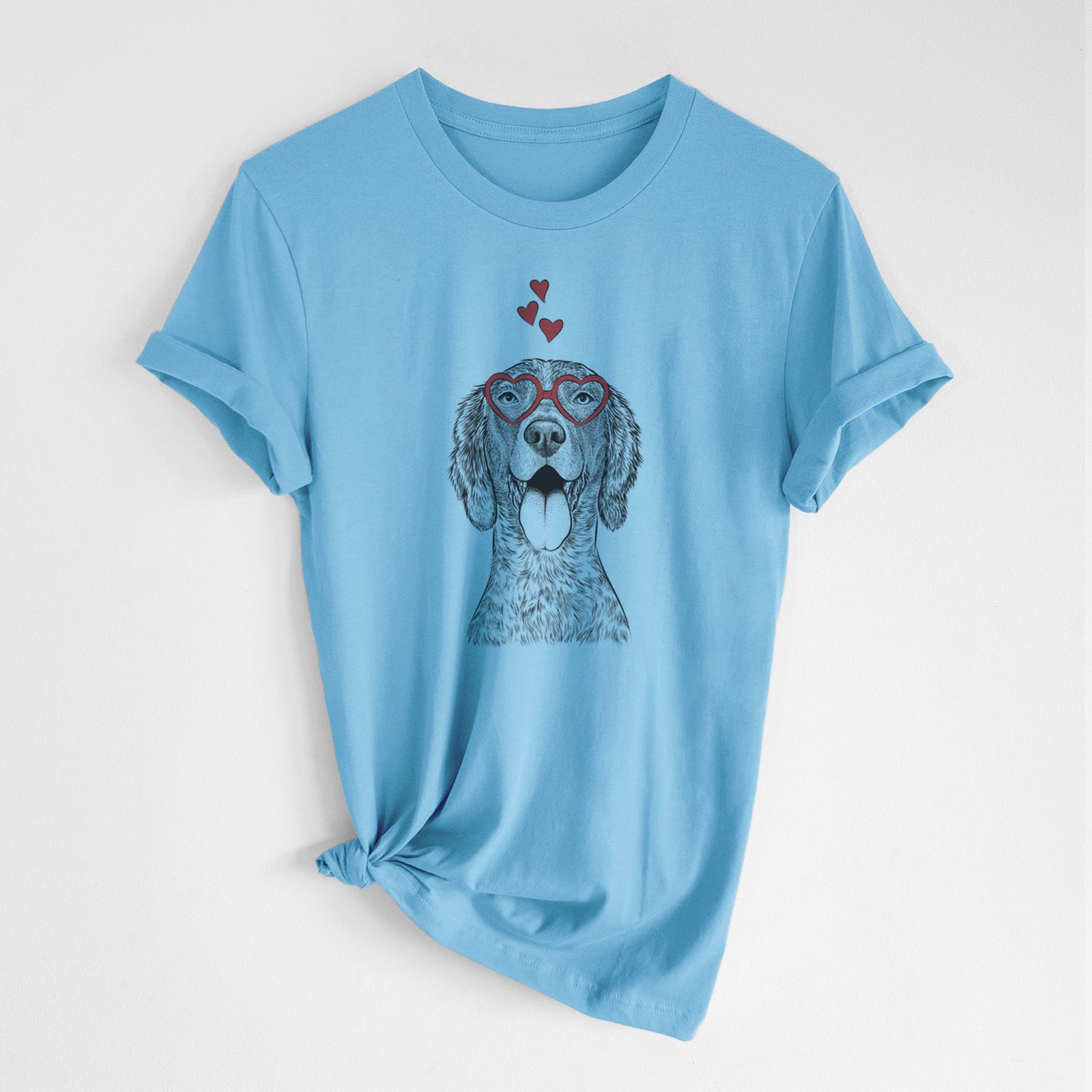 Hand-drawn sketch of Freddy the English Setter wearing heart-shaped glasses on an Ocean Blue Unisex crewneck, worn by a woman