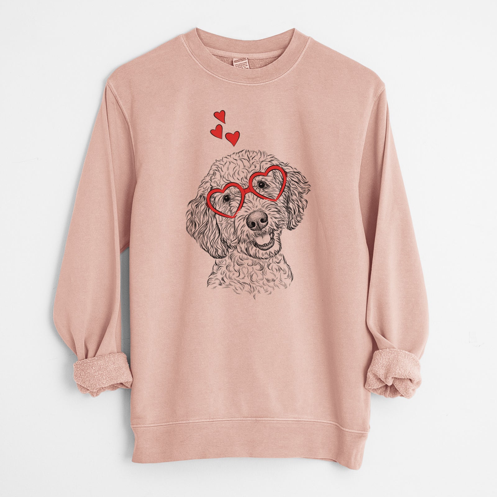 Hand-drawn sketch of Gizmo the Goldendoodle wearing heart-shaped glasses on a Dusty Pink Unisex pigment dyed crew sweatshirt