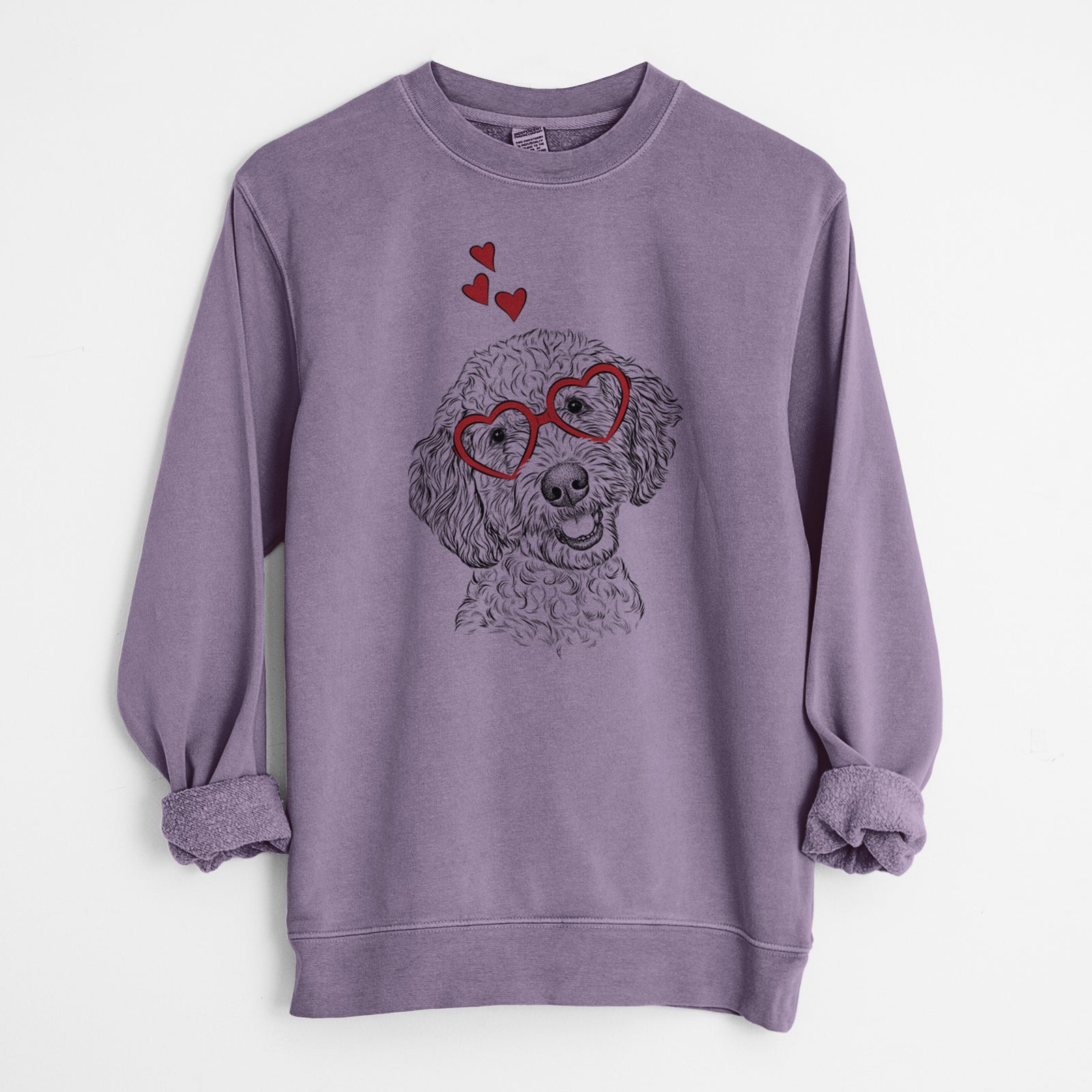 Hand-drawn sketch of Gizmo the Goldendoodle wearing heart-shaped glasses on a Plum Unisex pigment dyed crew sweatshirt