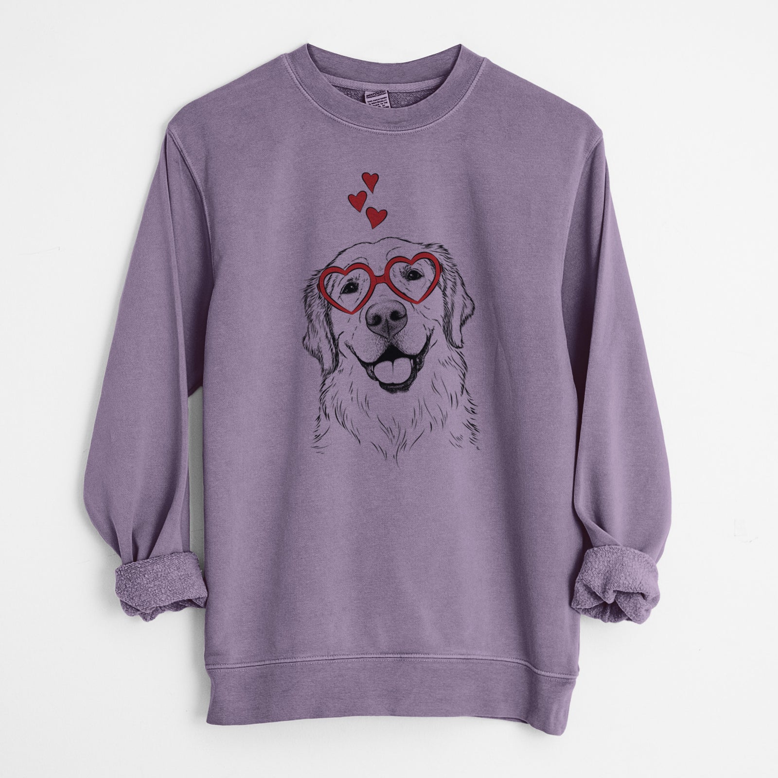 Hand-drawn sketch of Griffin the Golden Retriever wearing heart-shaped glasses on a Plum Unisex pigment dyed crew sweatshirt