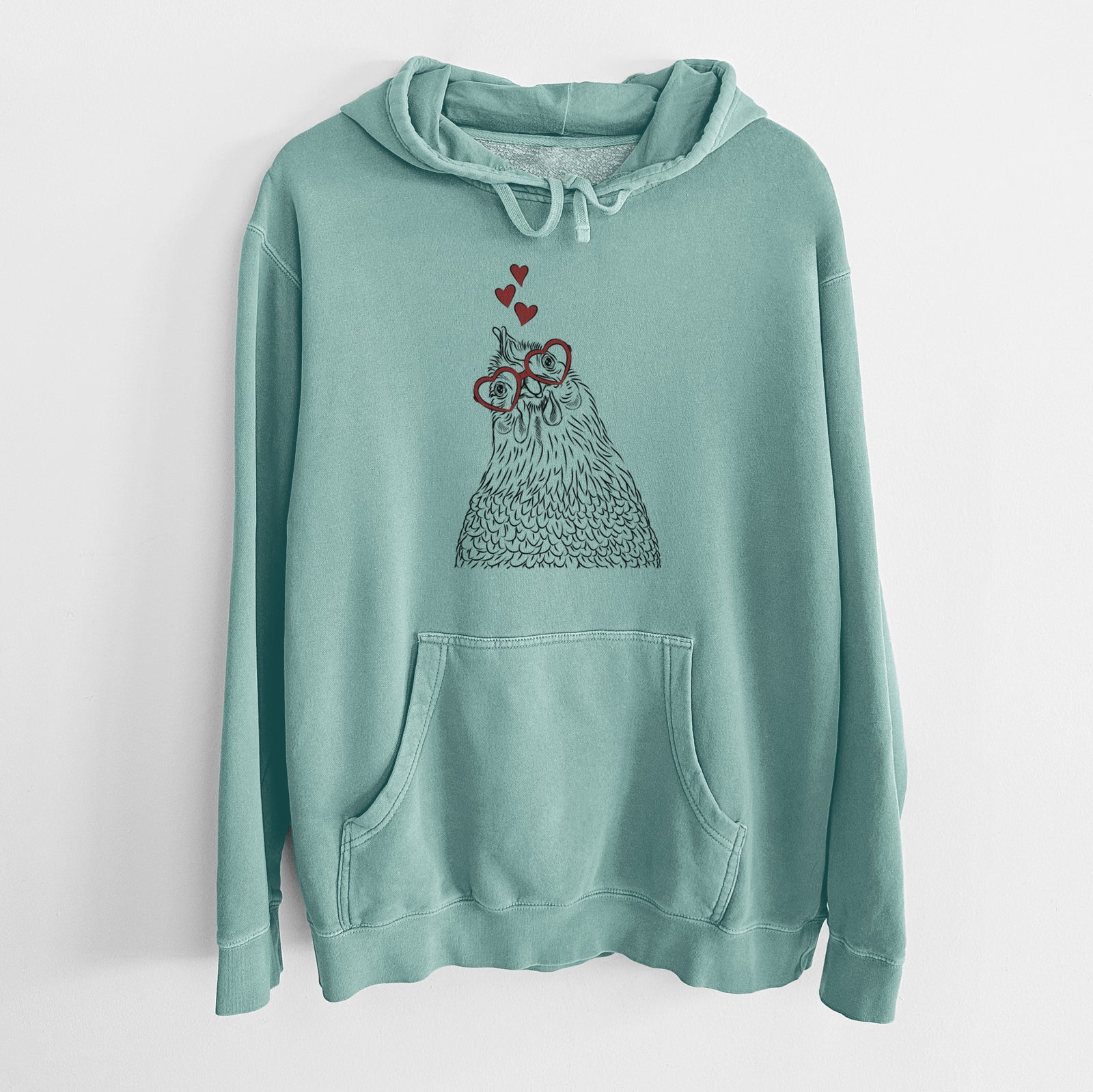 Hand-drawn sketch of Henrietta the Chicken wearing heart-shaped glasses on a Mint Unisex pigment dyed hoodie