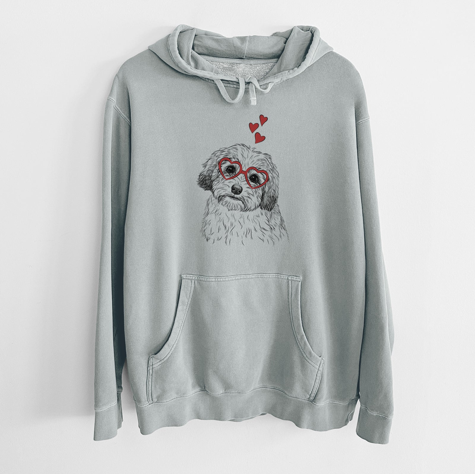 Hand-drawn sketch of Henry the Havanese wearing heart-shaped glasses on a Sage Unisex pigment dyed hoodie
