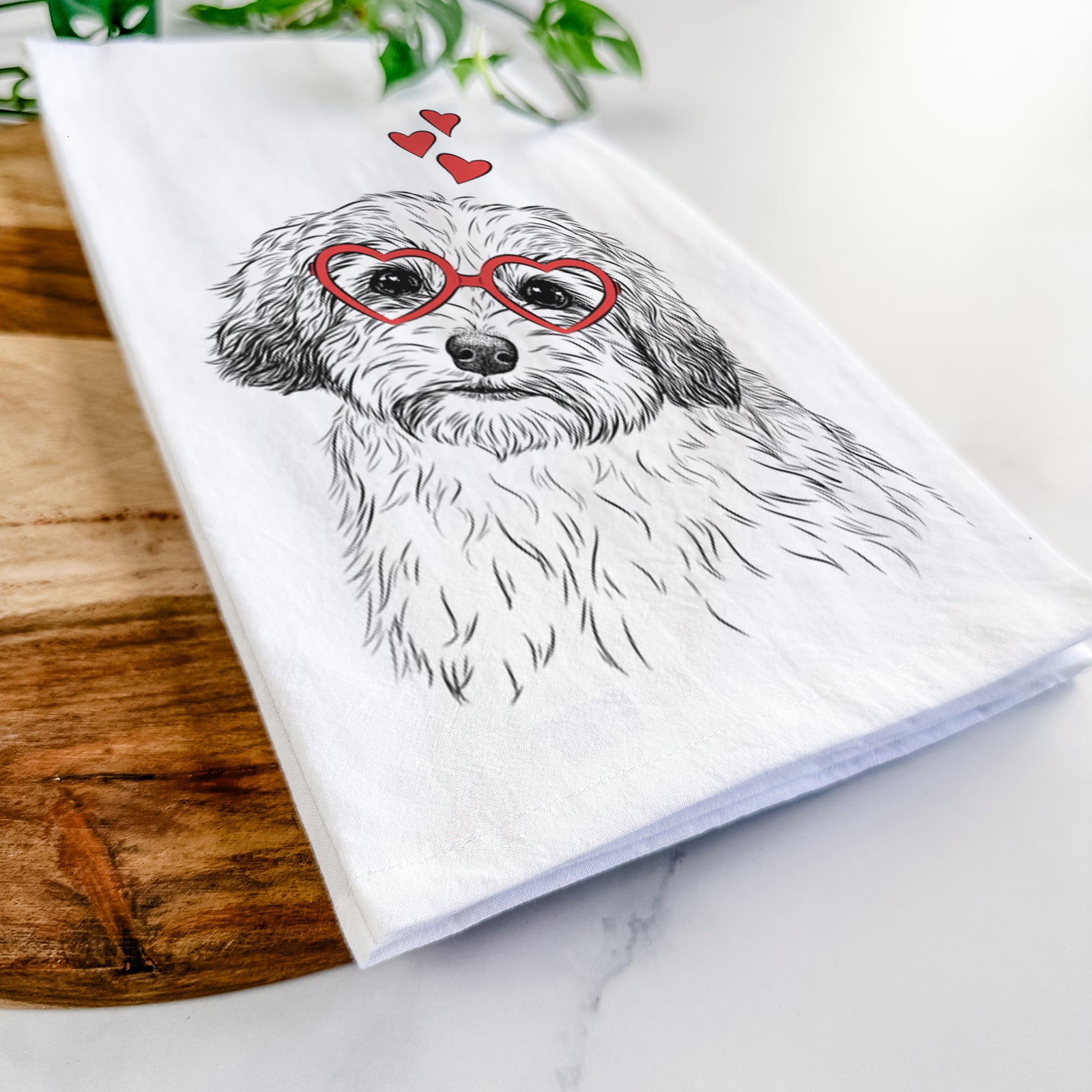 Hand-drawn sketch of Henry the Havanese wearing heart-shaped glasses on a tea towel