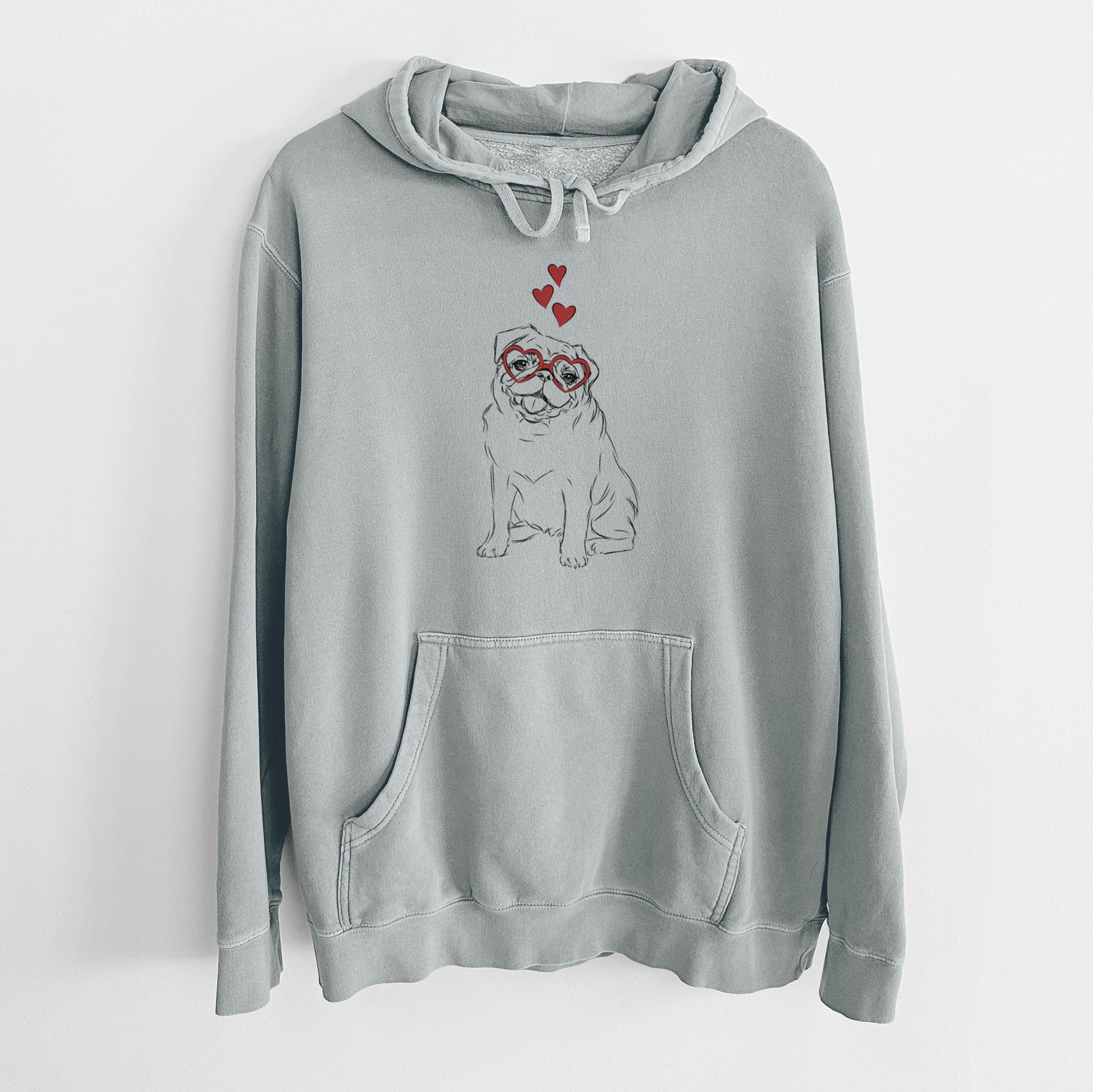Hand-drawn sketch of Higgins the Pug wearing heart-shaped glasses on a Sage Unisex pigment dyed hoodie
