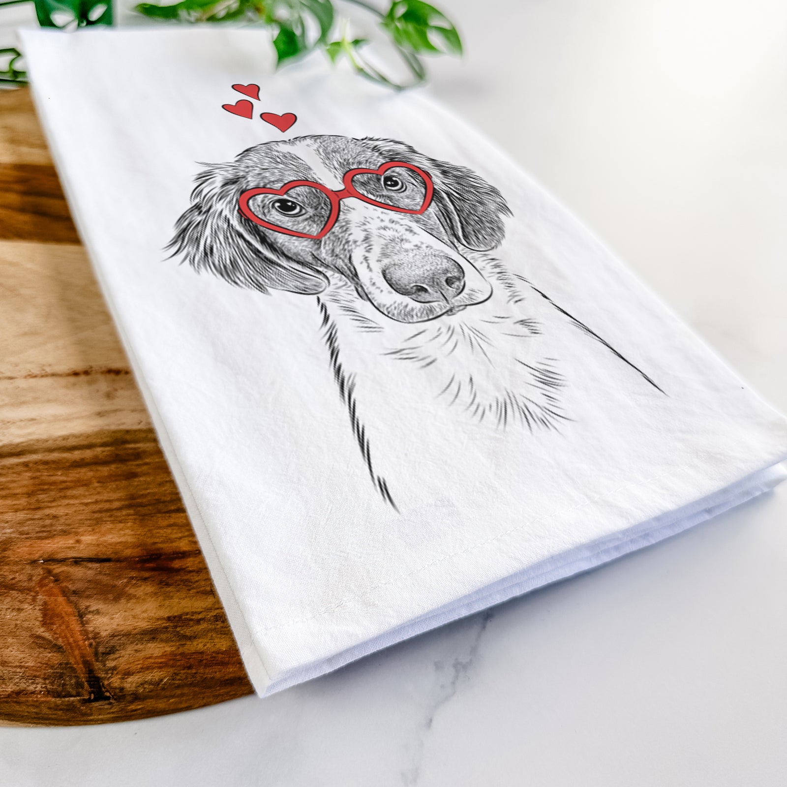 Hand-drawn sketch of Holly the Brittany Spaniel wearing heart-shaped glasses on a tea towel