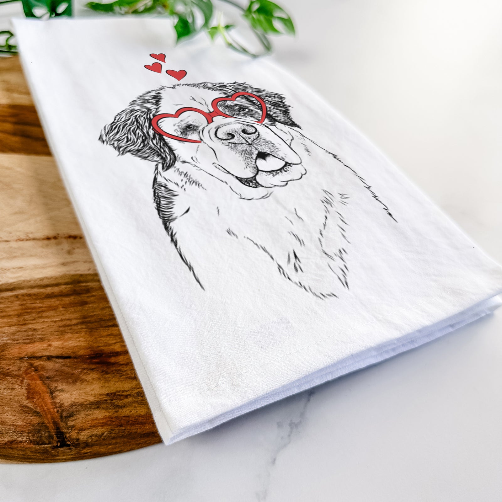 Hand-drawn sketch of Hook the Saint Bernard wearing heart-shaped glasses on a tea towel