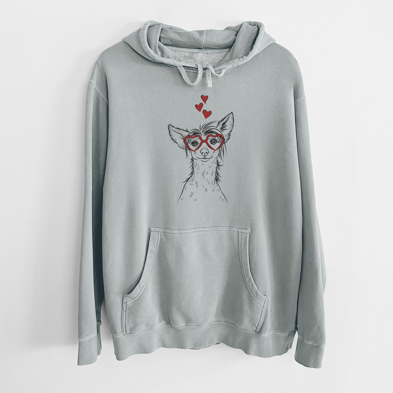 Hand-drawn sketch of Hudson the Chinese Crested wearing heart-shaped glasses on a Sage Unisex pigment dyed hoodie