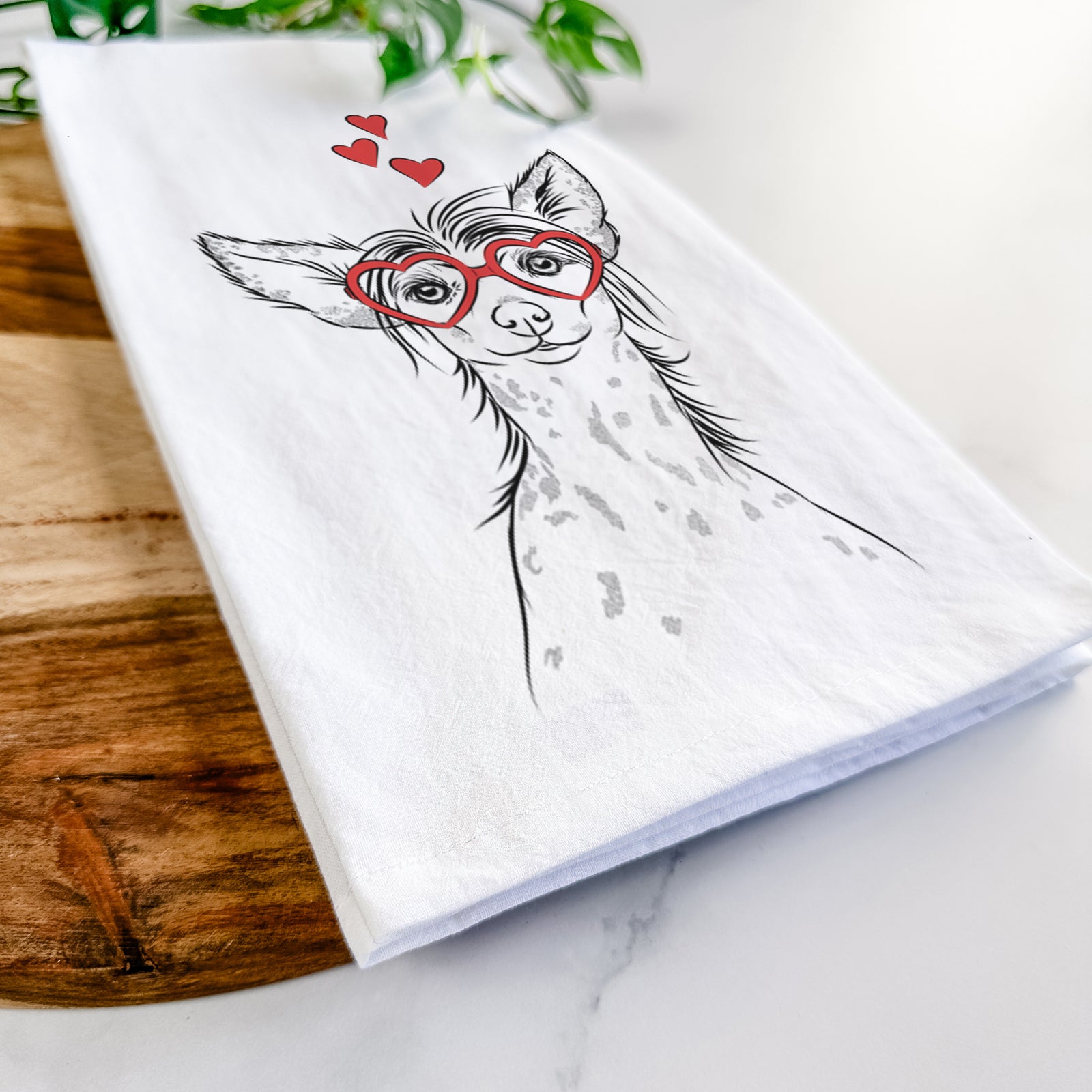 Hand-drawn sketch of Hudson the Chinese Crested wearing heart-shaped glasses on a tea towel