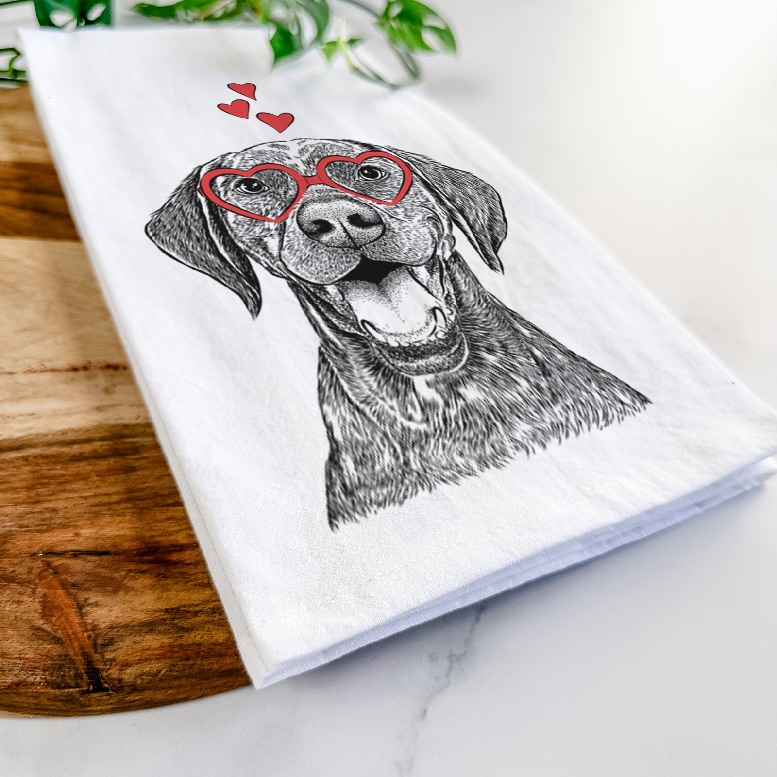 Hand-drawn sketch of Hudson the German Shorthaired Pointer wearing heart-shaped glasses on a tea towel