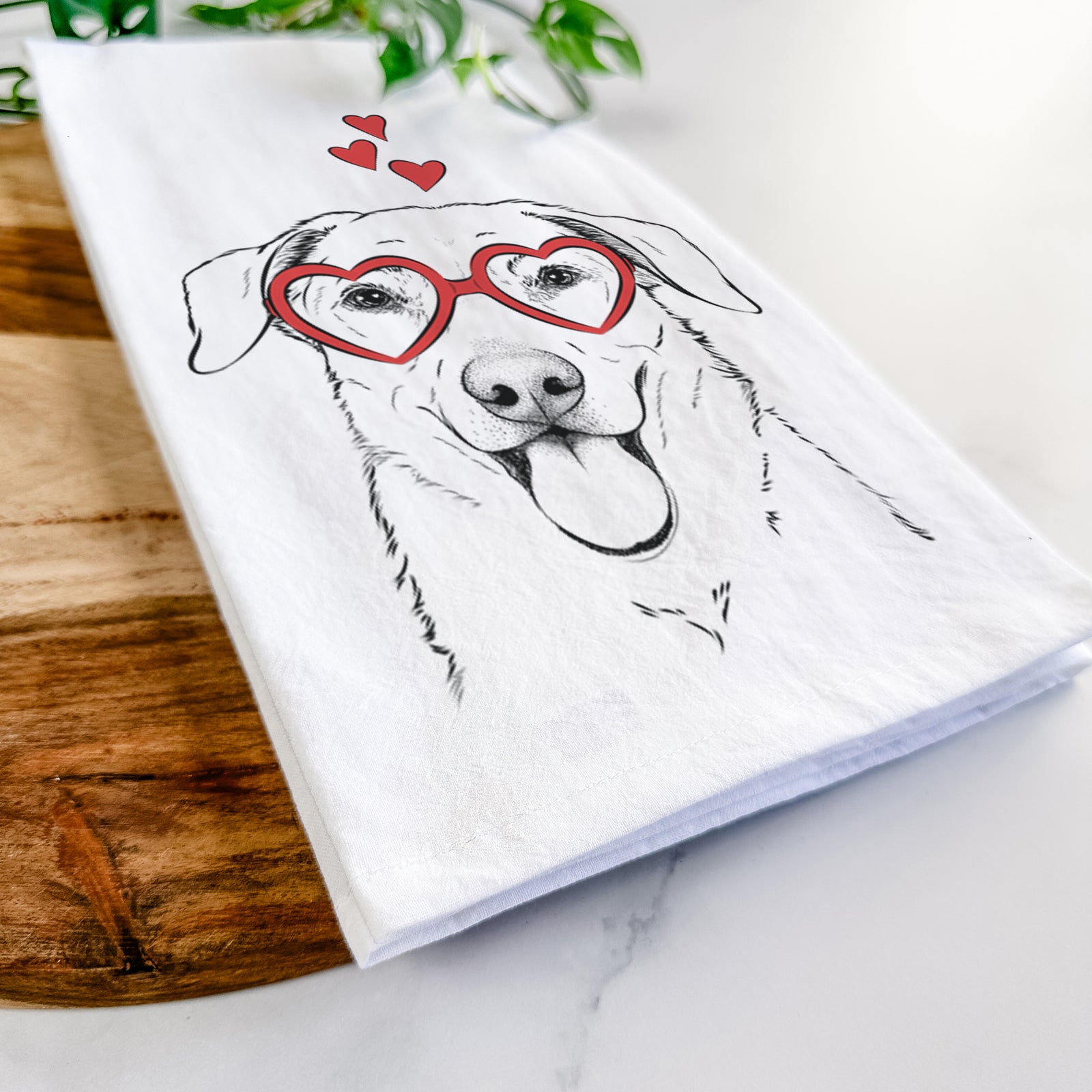 Hand-drawn sketch of Hudson the Shepherd wearing heart-shaped glasses on a tea towel