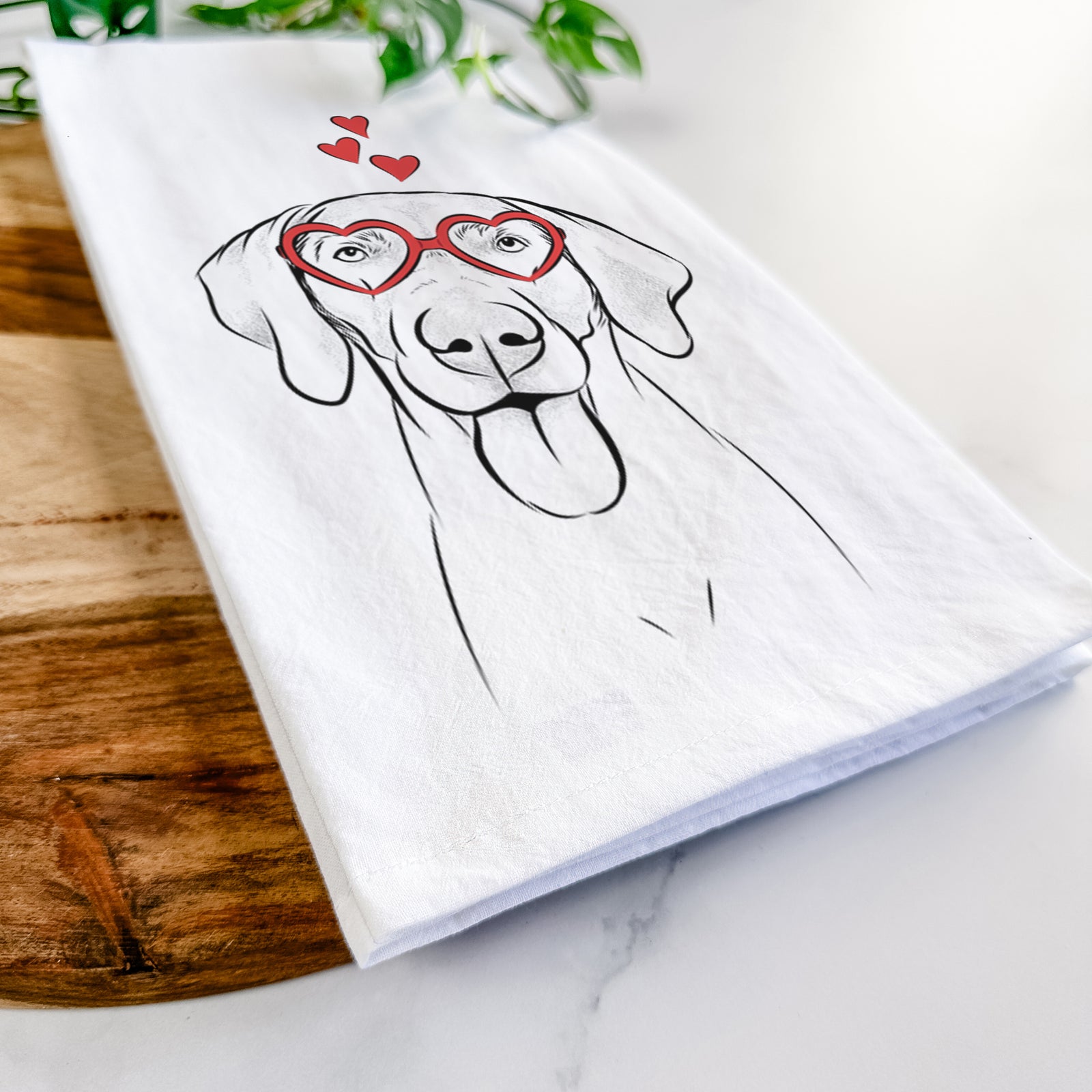 Hand-drawn sketch of Jackson the Weimaraner wearing heart-shaped glasses on a tea towel