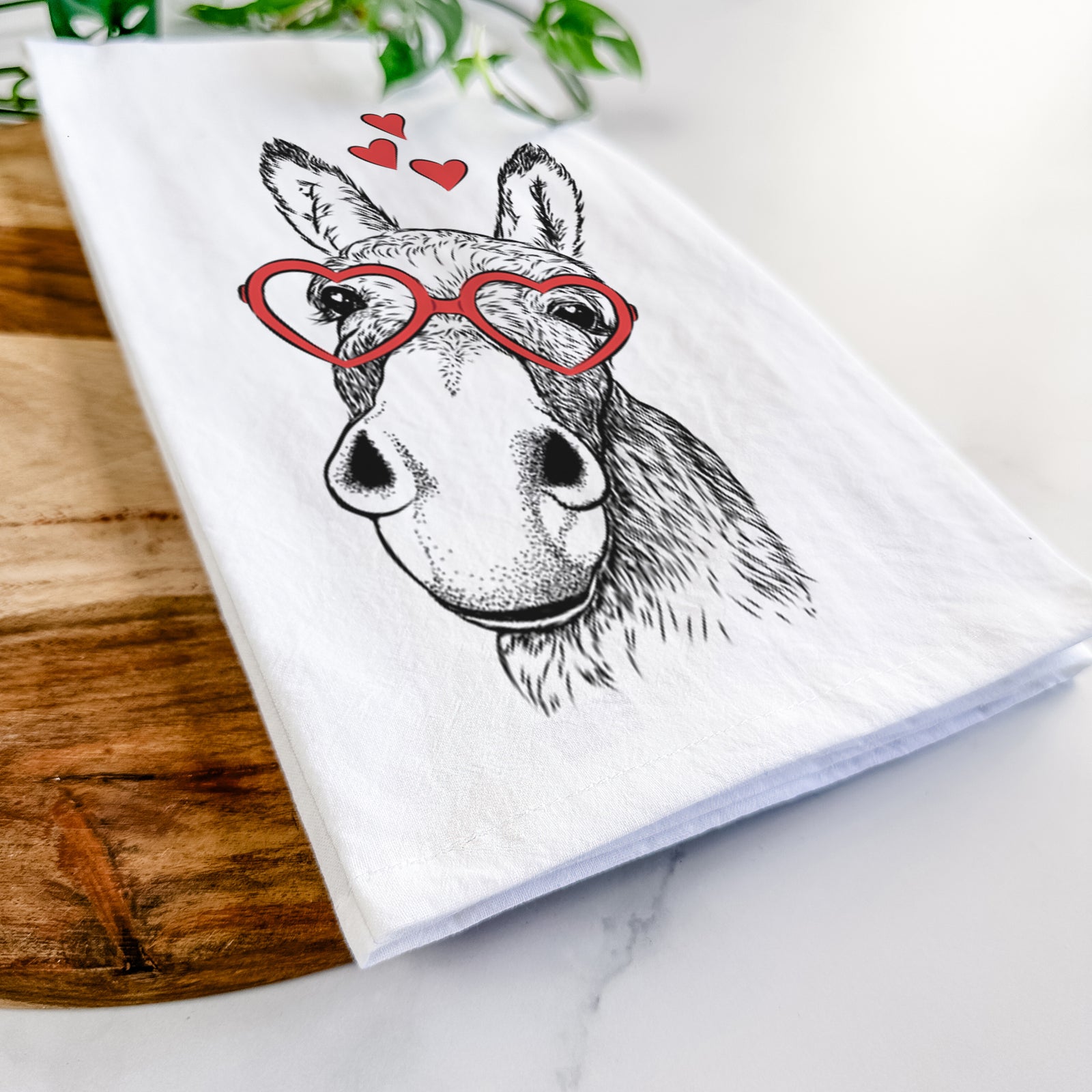 Hand-drawn sketch of Jenny the Donkey wearing heart-shaped glasses on a tea towel