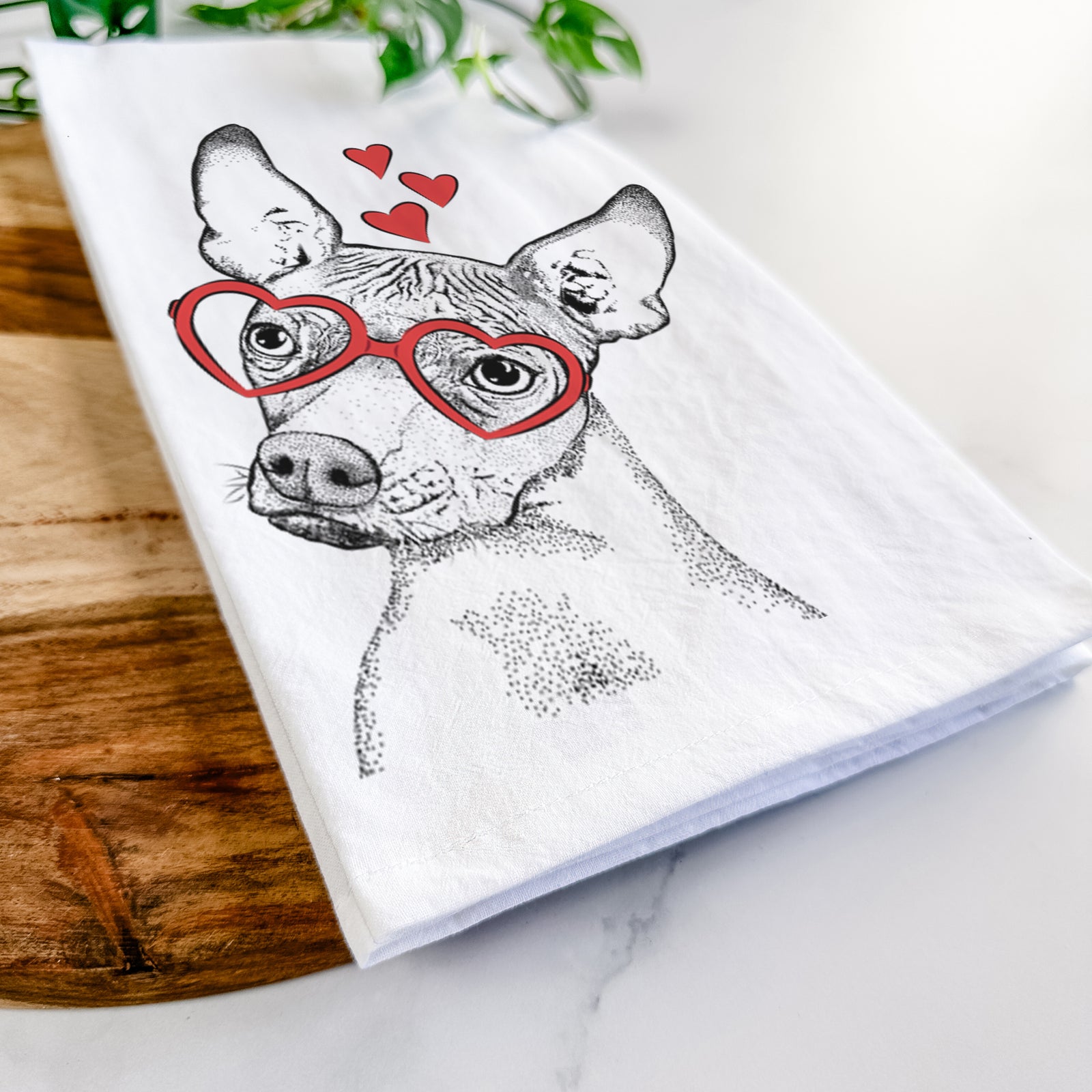 Hand-drawn sketch of Kahlo the Xoloitzcuintli wearing heart-shaped glasses on a tea towel