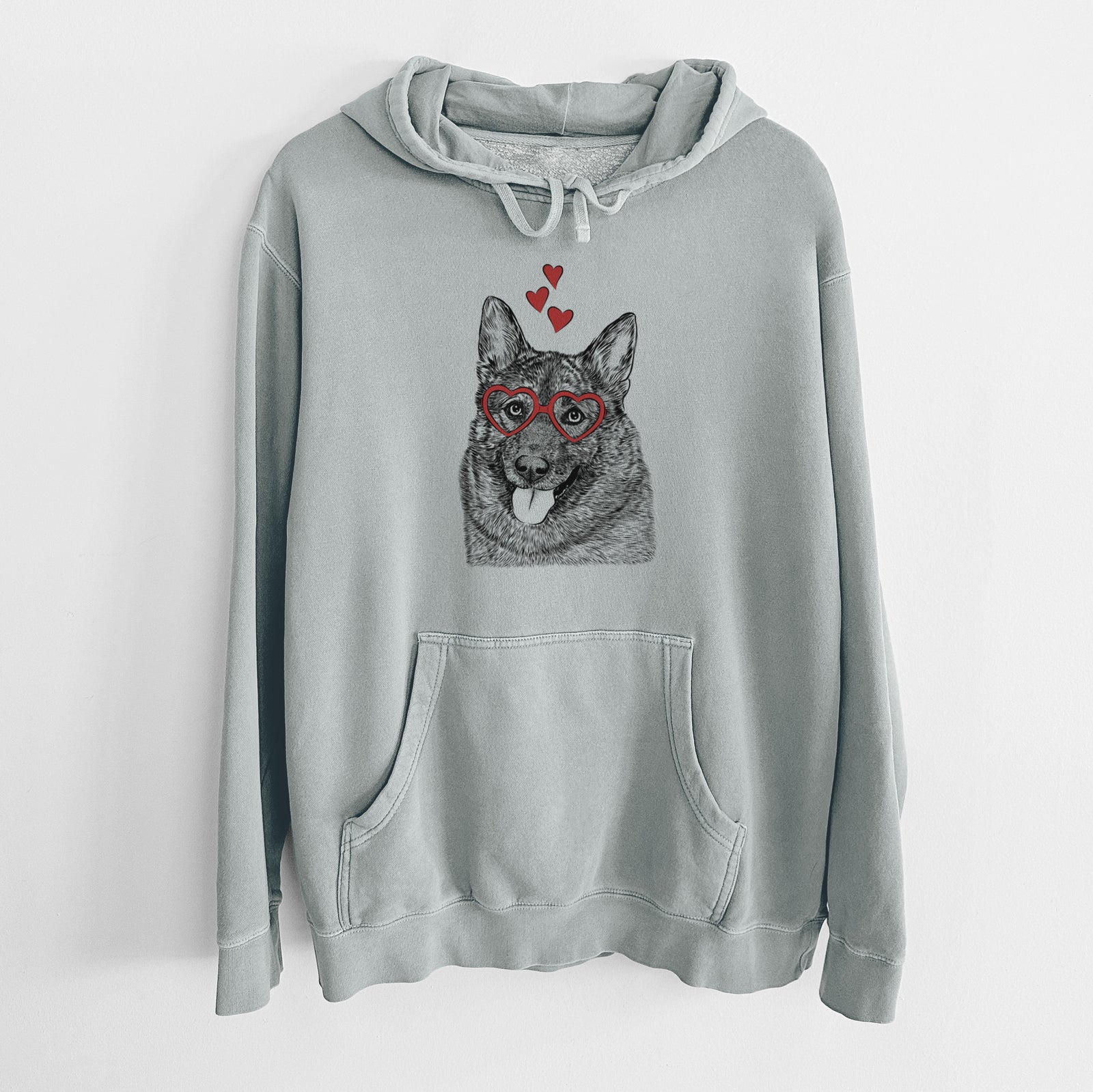 Hand-drawn sketch of Kasia the Norwegian Elkhound wearing heart-shaped glasses on a Sage Unisex pigment dyed hoodie