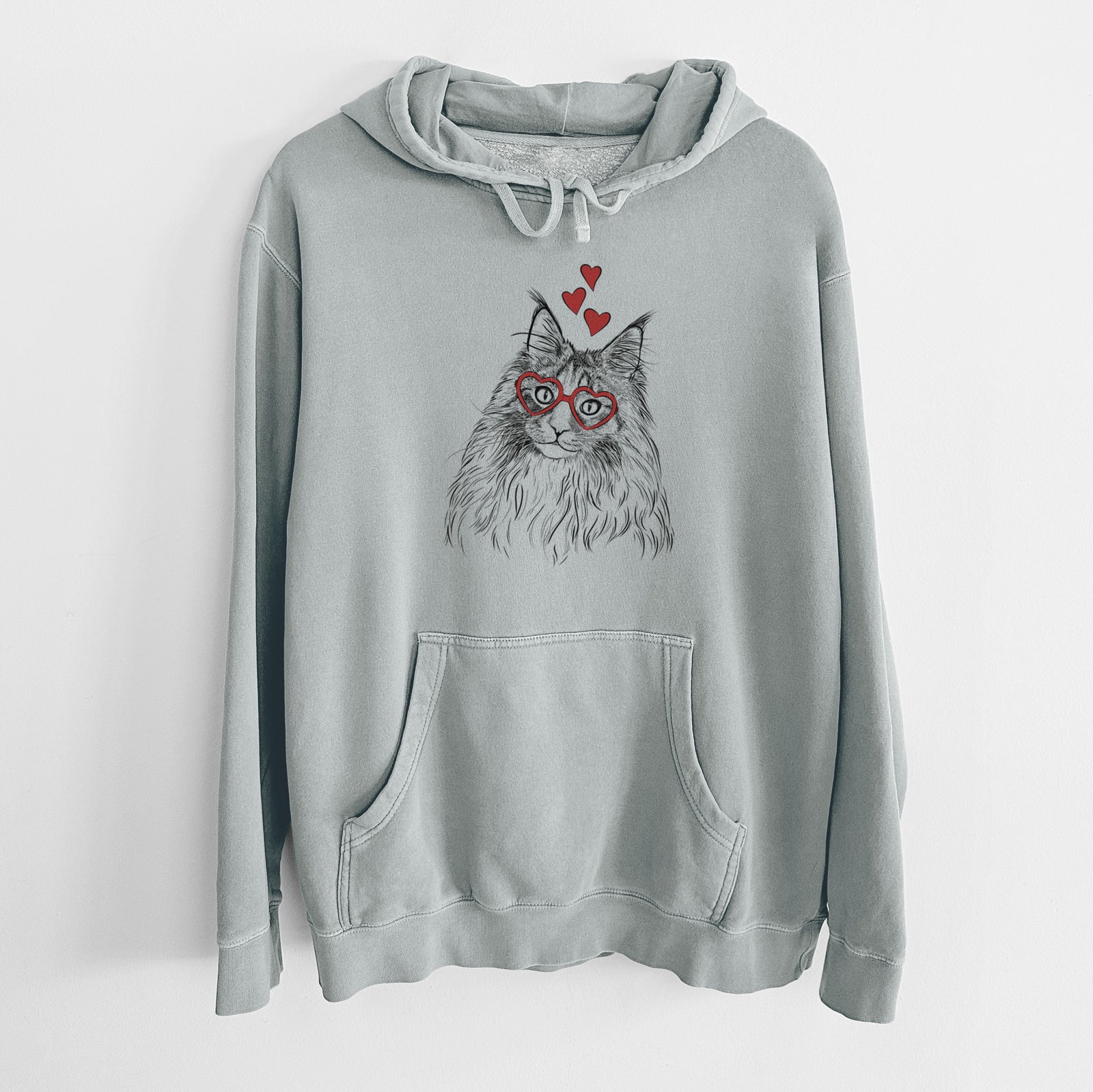 Hand-drawn sketch of Kiki the Maine Coon Cat wearing heart-shaped glasses on a Sage Unisex pigment dyed hoodie