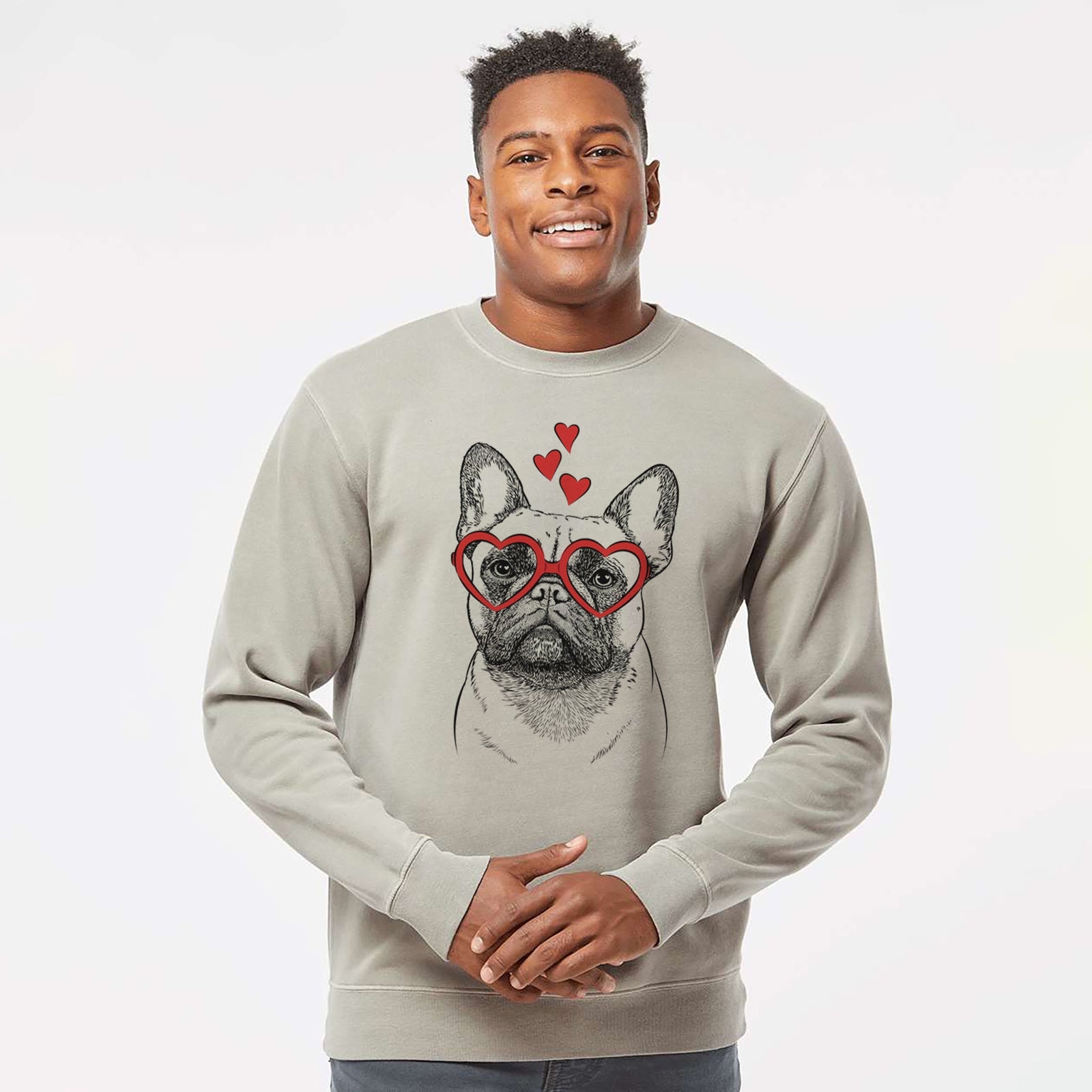 Hand-drawn sketch of Kingsleigh the French Bulldog wearing heart-shaped glasses on a Cement Unisex pigment dyed crew sweatshirt